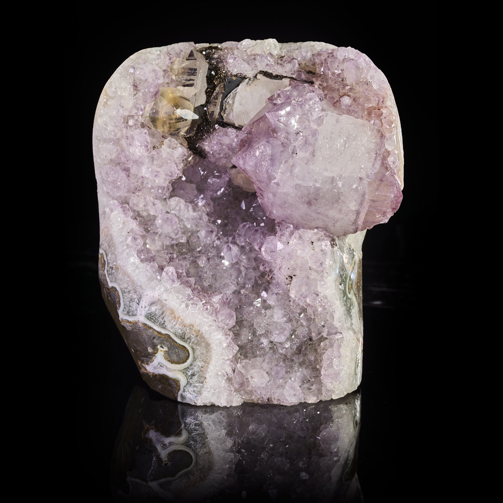 Image Description: A front angle shot of a amethyst freeform with calcite and tourmaline.