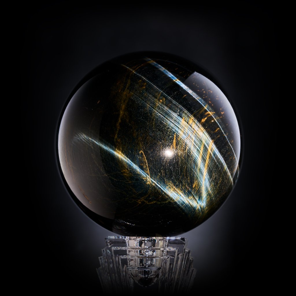 Image Description: A Tiger's Eye sphere with golden orange patterns and impressive blue flashes.
