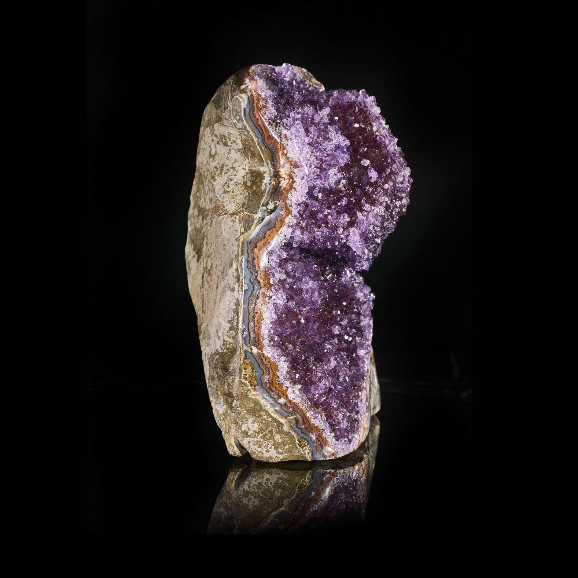 Image Description: An alternate side angle view of a purple amethyst freeform piece with a cubic calcite formation.