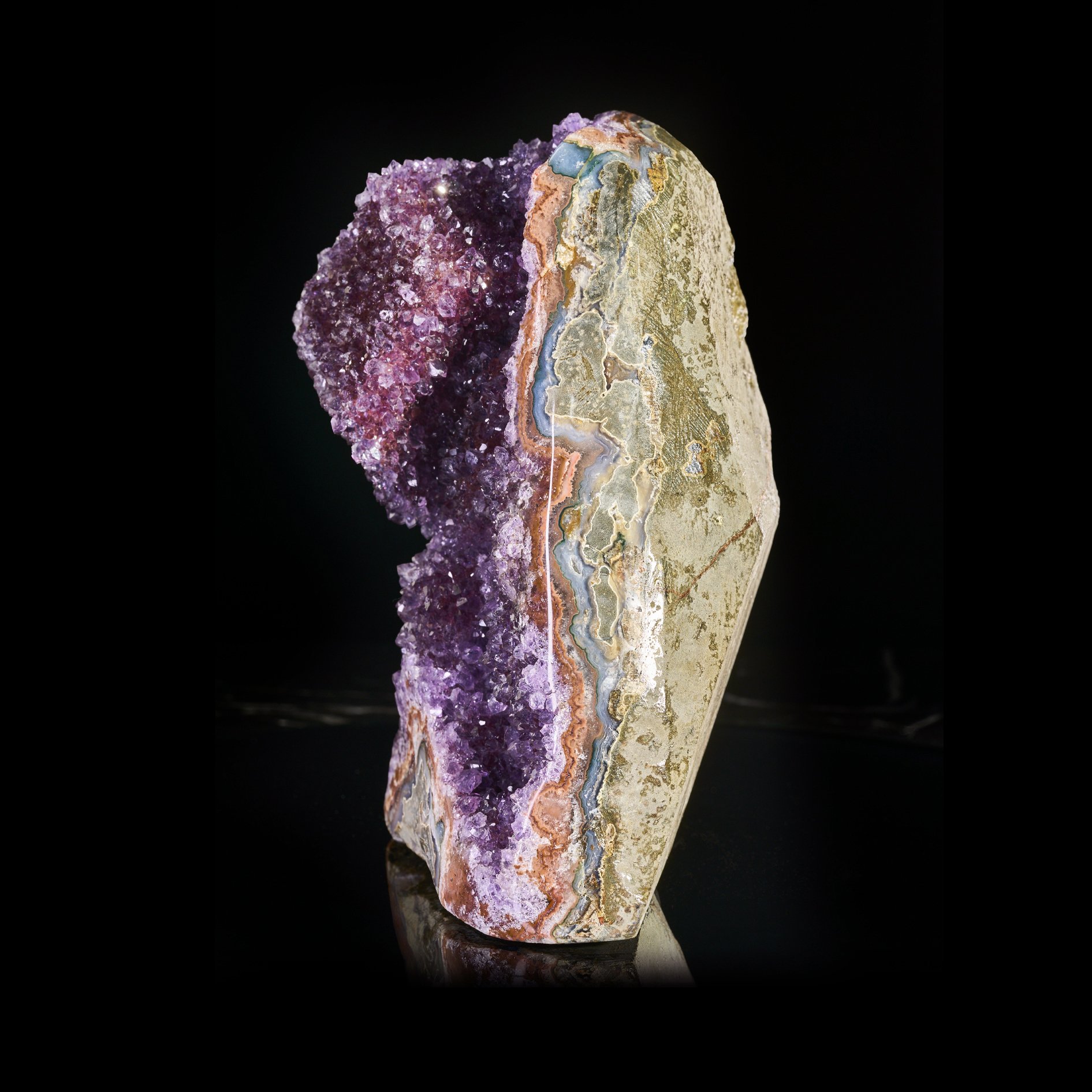Image Description: A side angle view of a purple amethyst freeform piece with a cubic calcite formation.