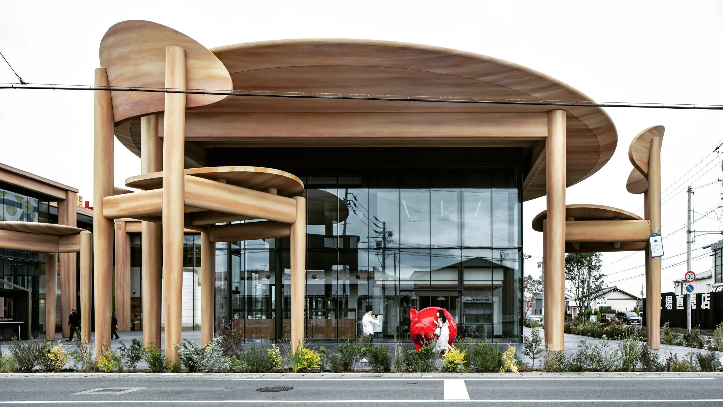 Nikken Sekkei shelters Japanese sweet company HQ with oversized table and chairs
