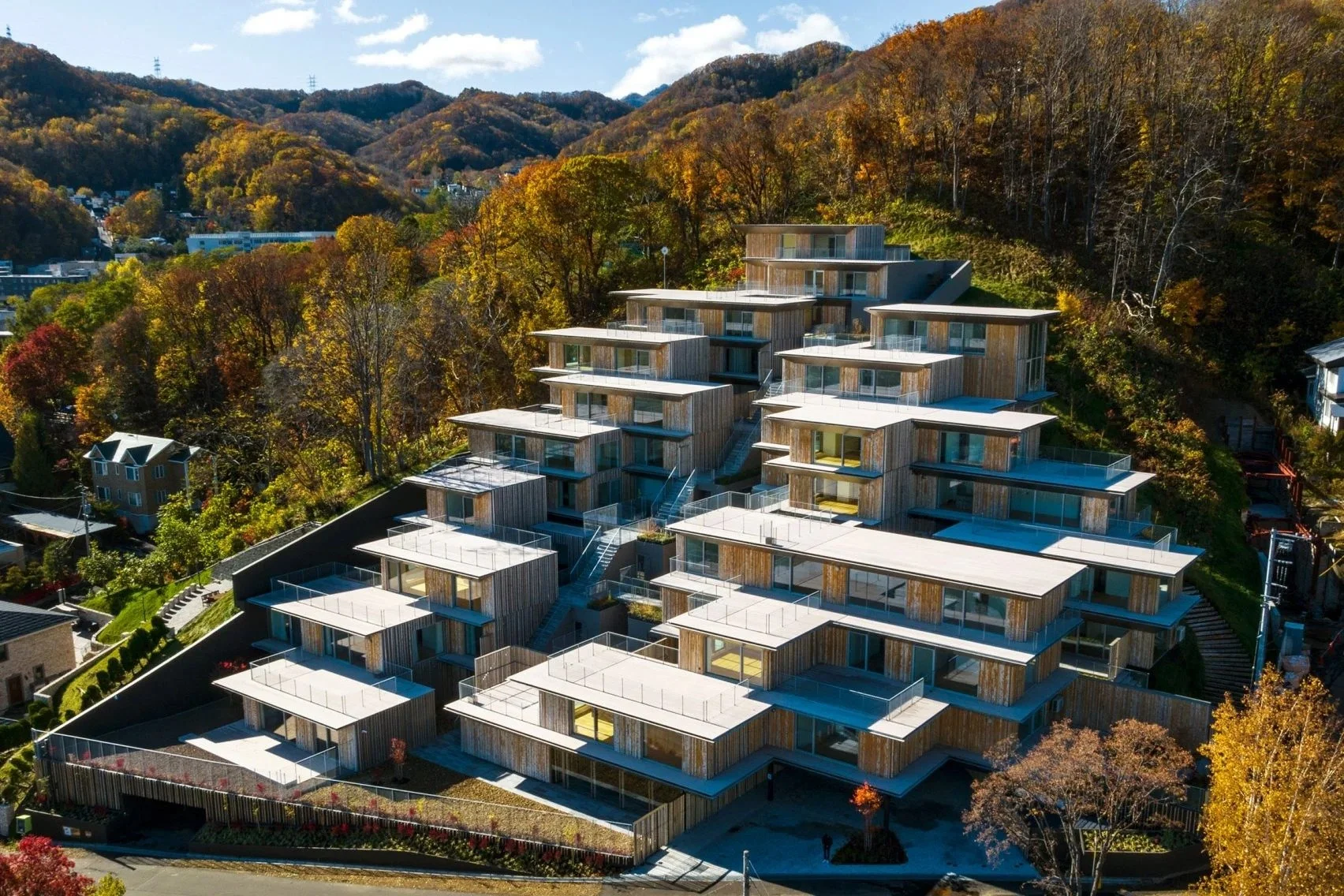 Kengo Kuma nestles staggered housing complex on Japanese hillside