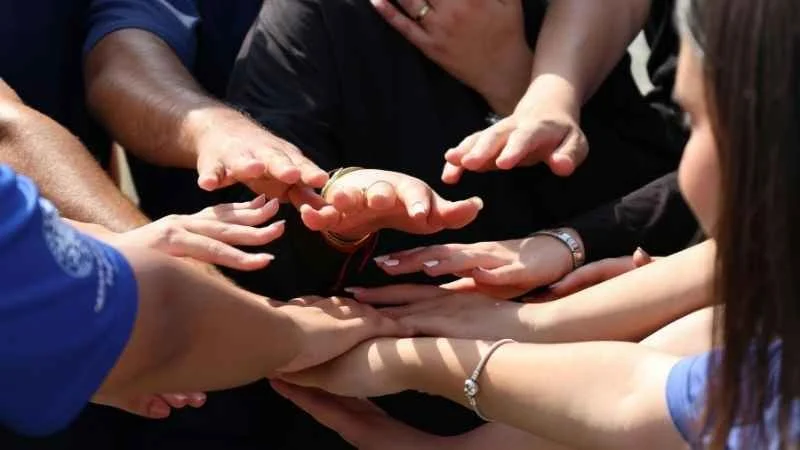 Community. Connection. Shared Memories. Hands coming together