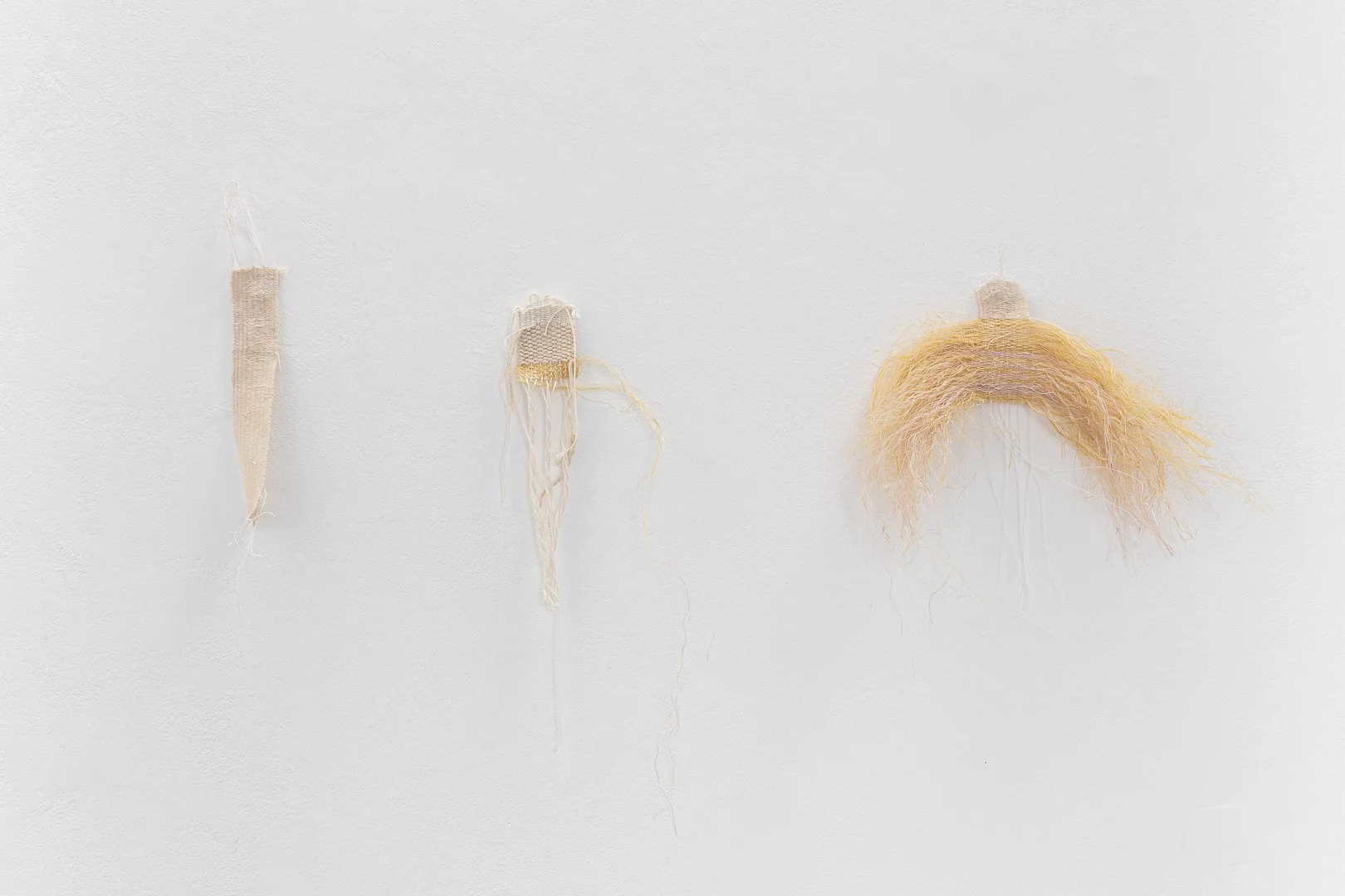 Theresa Goessmann, What will I become. Weaving. Cotton threads taken from canvas fabric, variable dimensions / The weight of what was meant to be said. Weaving. Cotton yarns, dyed sisal, variable dimensions / That day will come. Weaving, cotton threa