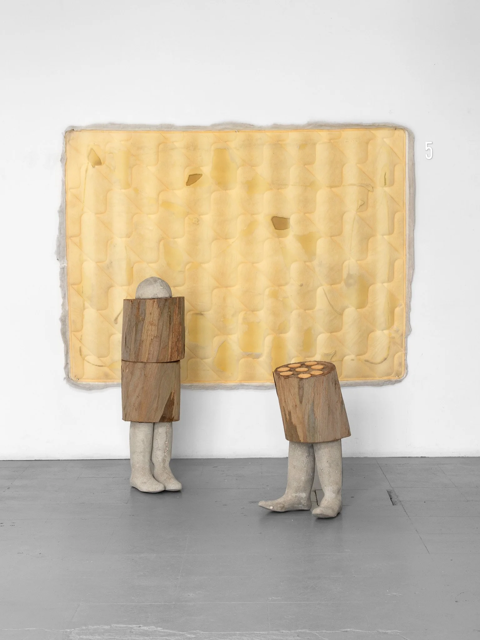 Dirk Hoogeveen, Two flies sitting in the kitchen. Reclaimed mattress, concrete, reclaimed wood, aluminium house number, 184 x 190 x 150 cm, 2026.
