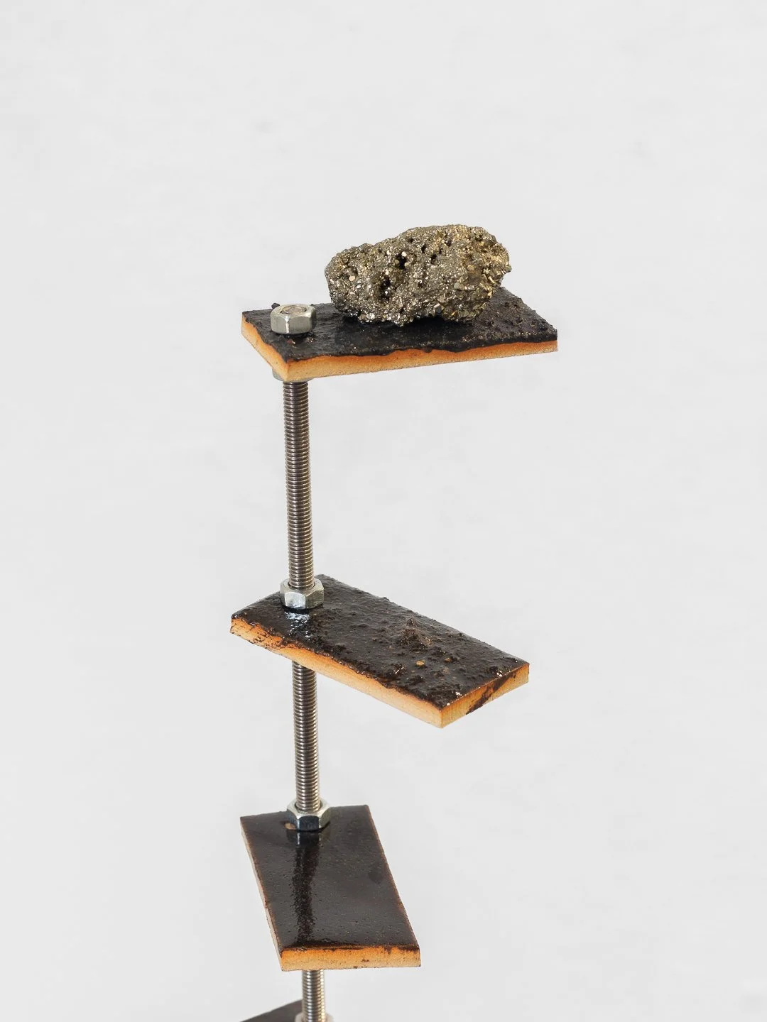 Gaia D’Arrigo, The fool’s playground. Ceramic, industrial waste glaze, unknown spheres, Pyrite 60 x 30 cm, 2026