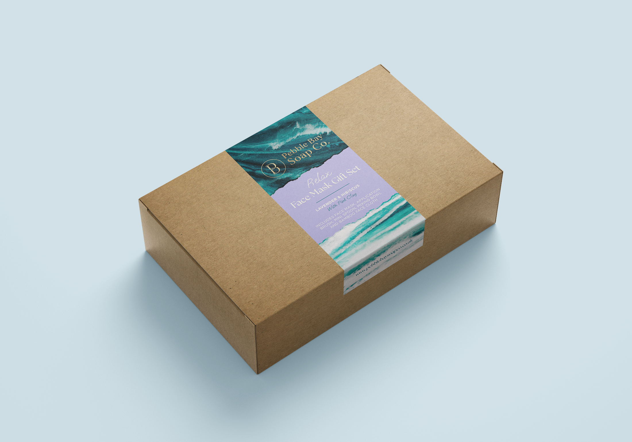 Box labeled 'Pebble Bay Soap Co. Relax Face Mask Gift Set' on a light blue background.