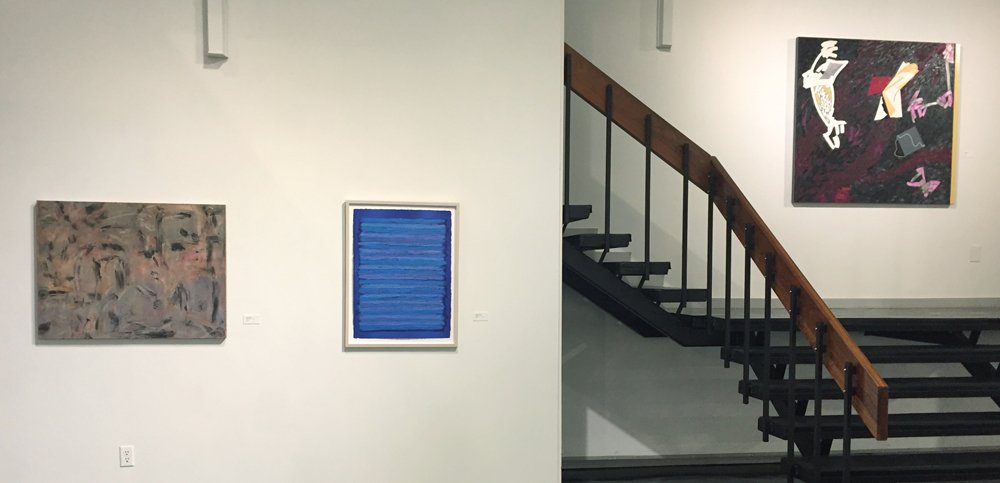 At left: works by Claire Seidl and Joanne Mattera. Over the stairs, a work by Judith Murray