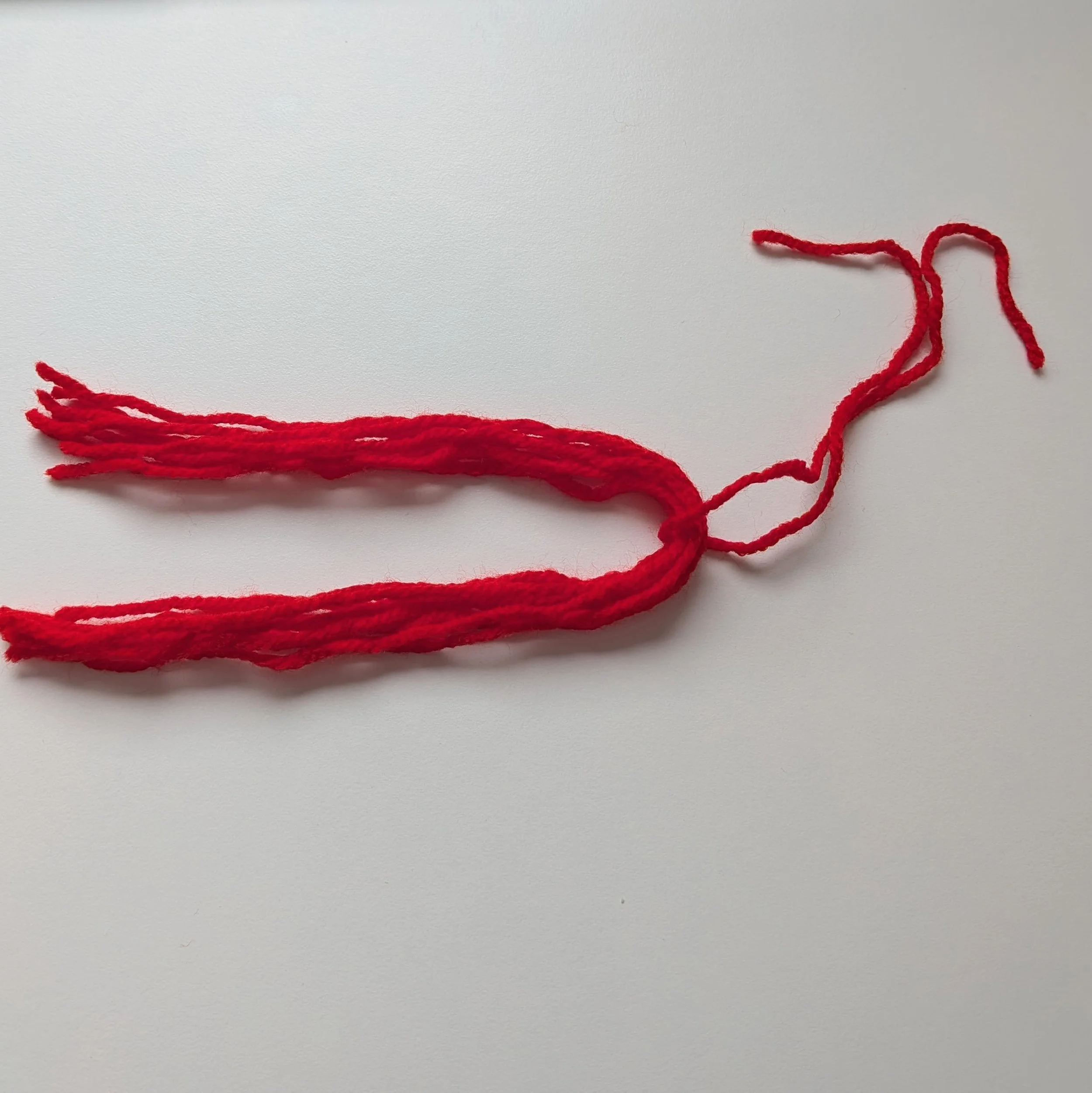 Fold in half and tie yarn