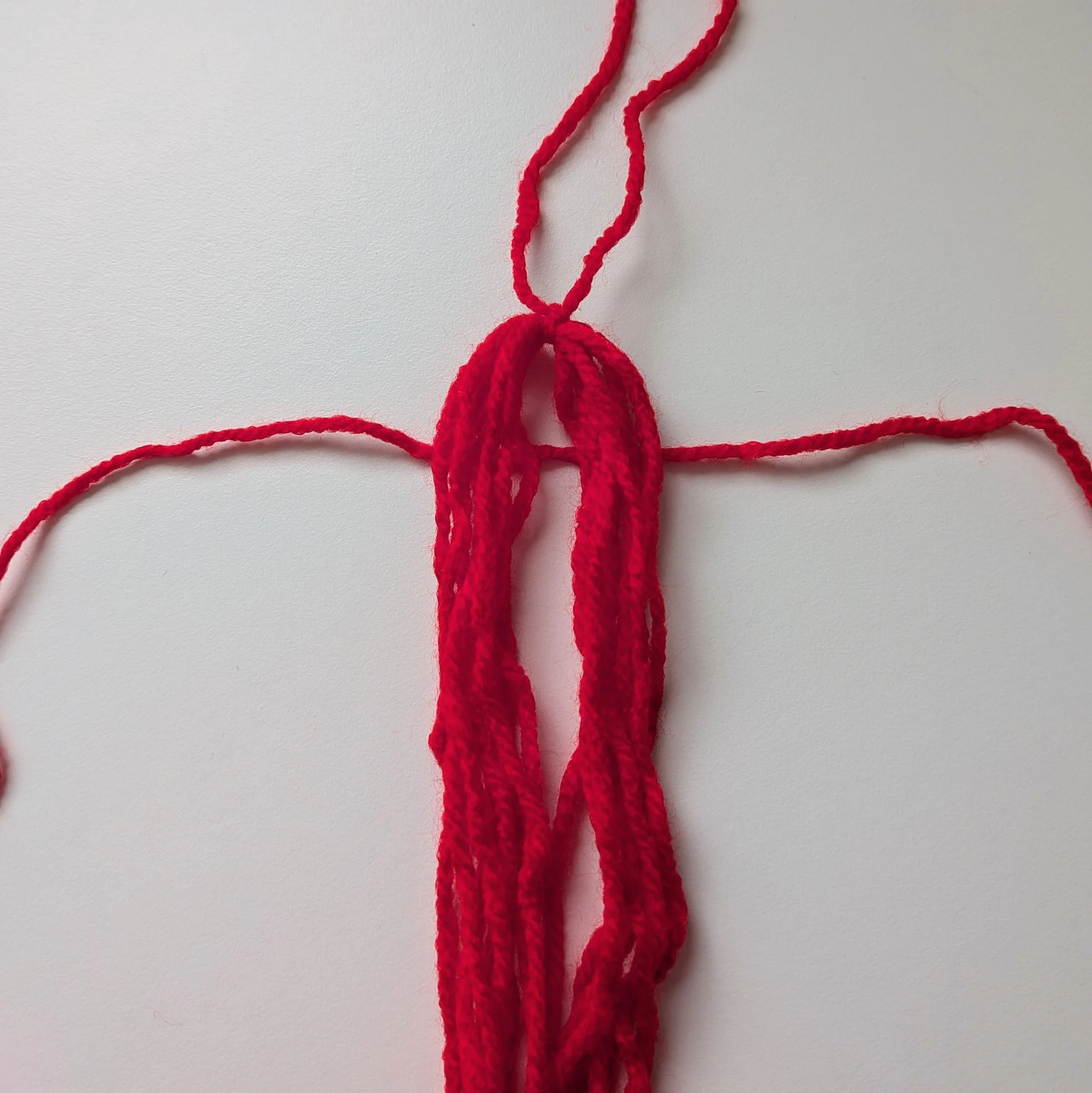 Tie yarn 2 cm below the first tie