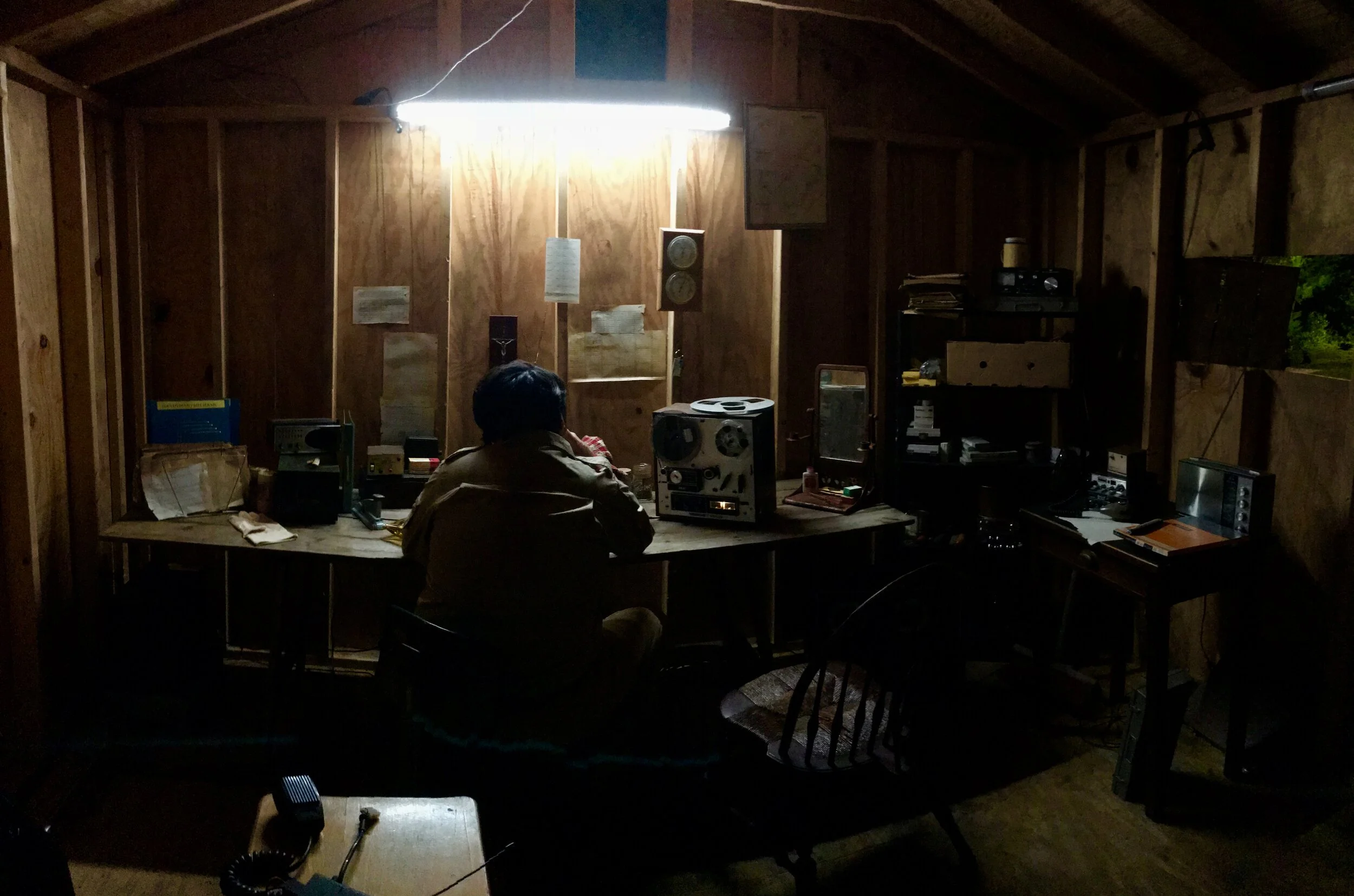 Jonestown INT. Jim Jones Radio Room 