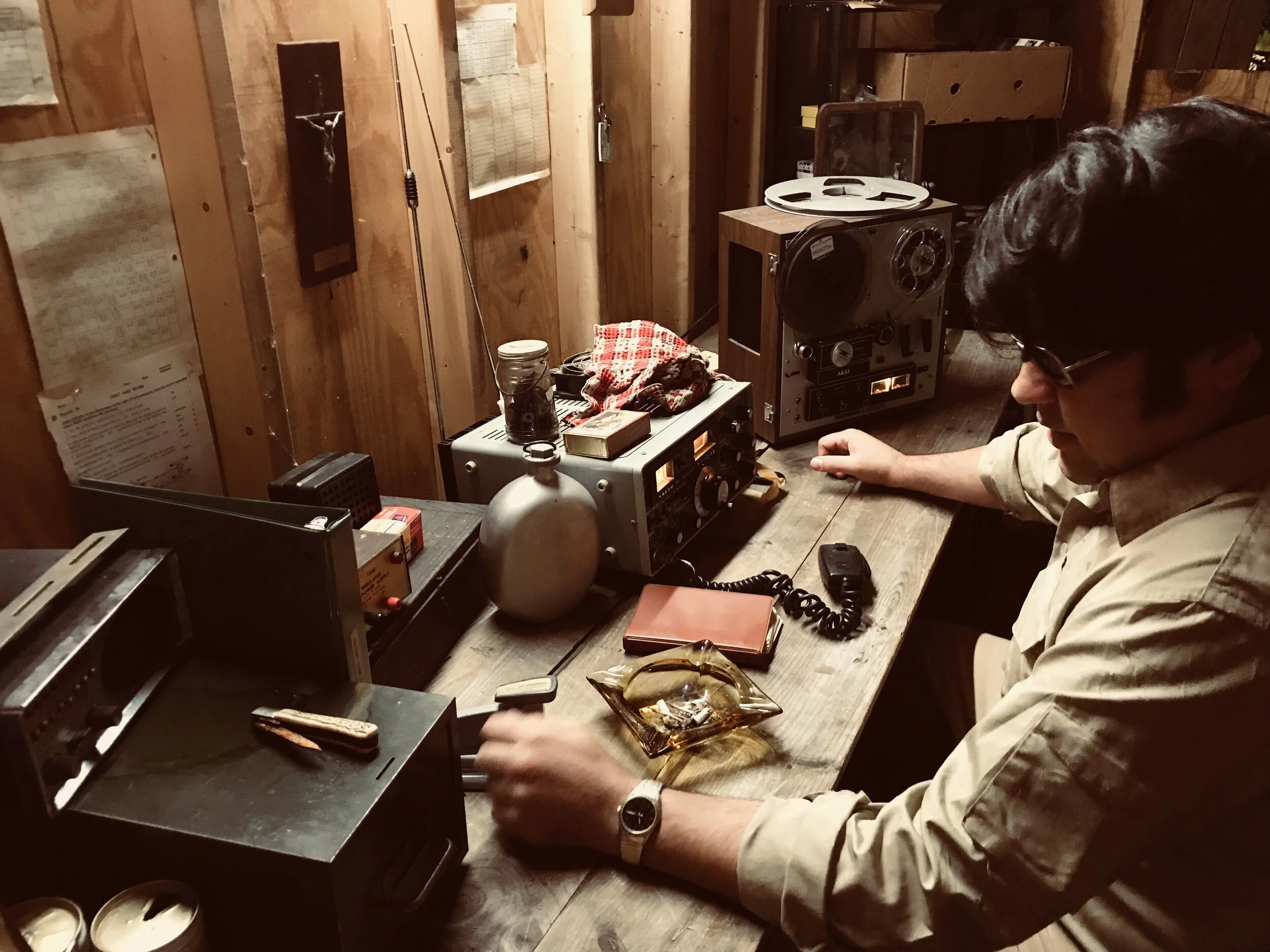 Jonestown INT. Jim Jones Radio Room 