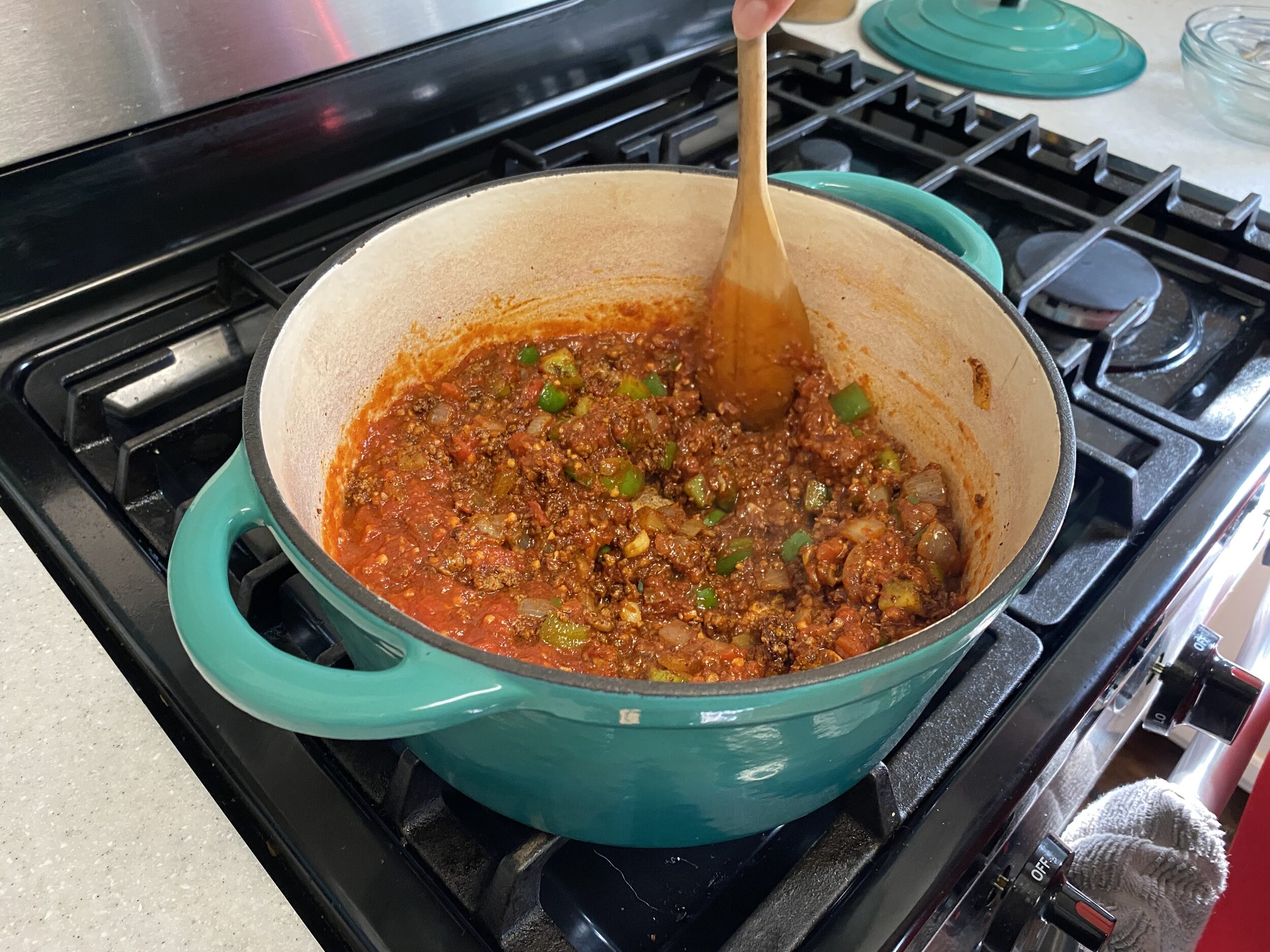Once you can smell the spices, add in the tomato and stir through. Make sure nothing is sticking to the bottom.