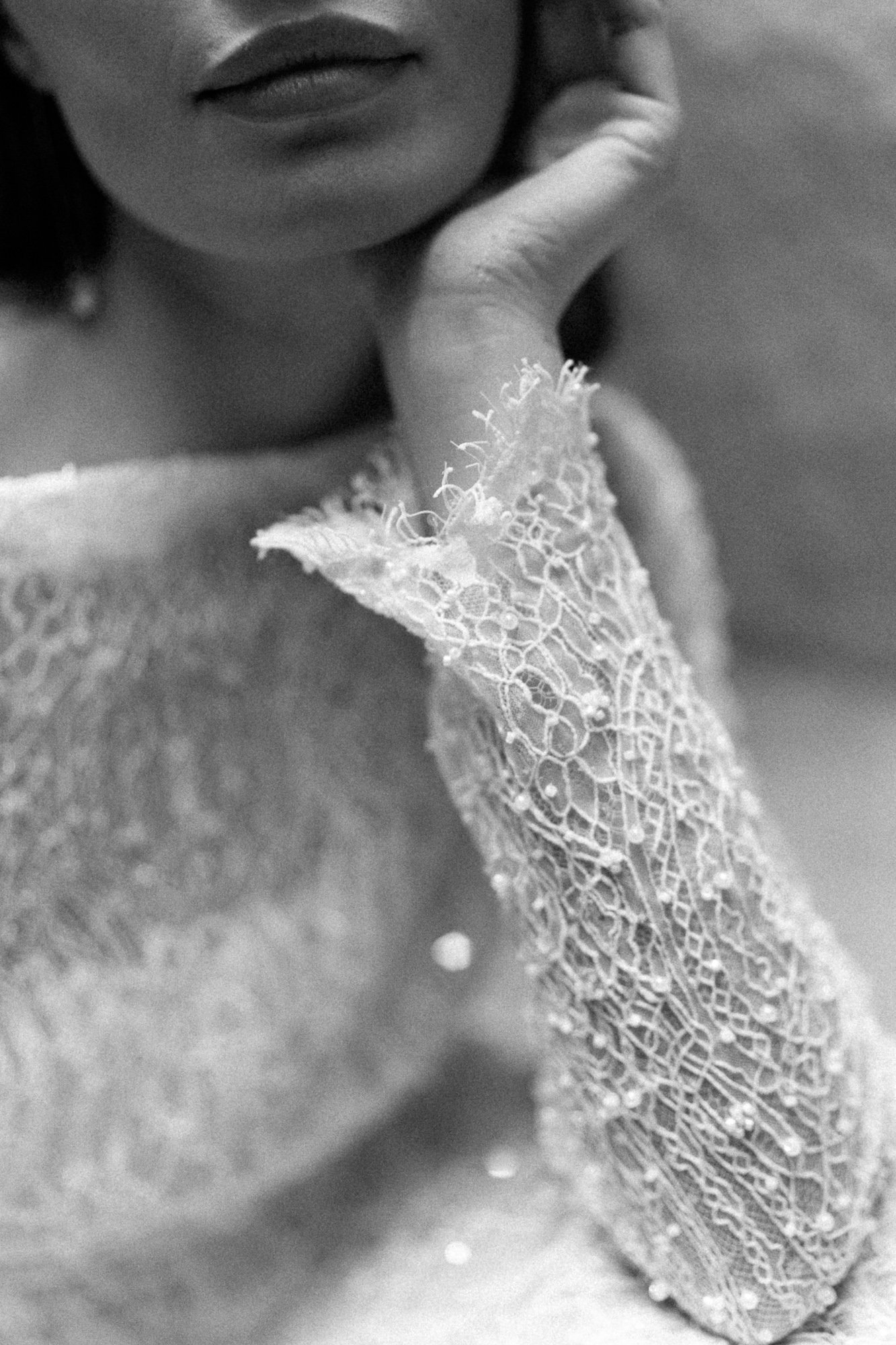 Woman in white dress with orange flower detail — editorial bridal portrait Tuscany