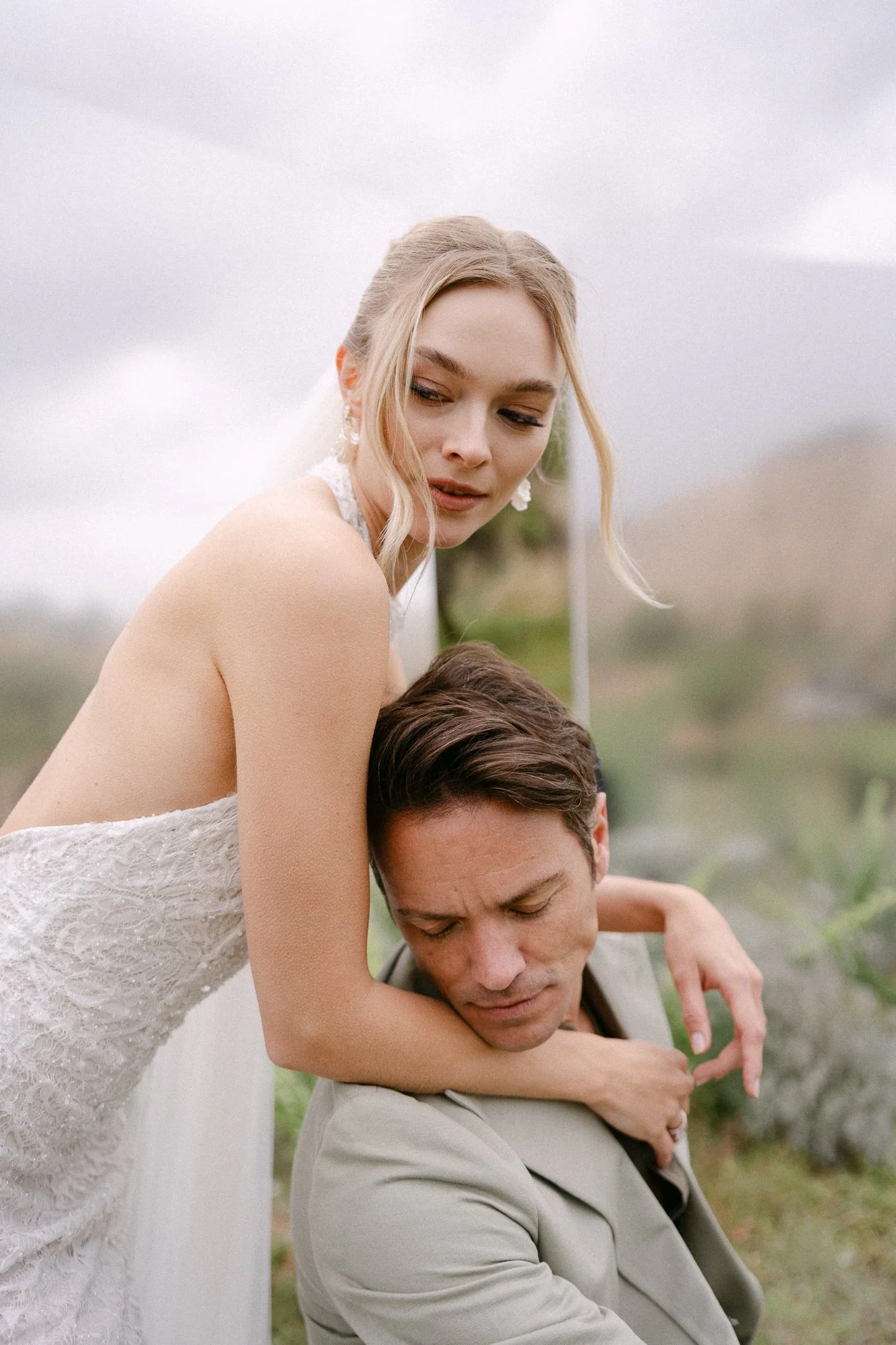 Couple embracing and laughing in Cappadocia landscape — authentic romantic wedding moment