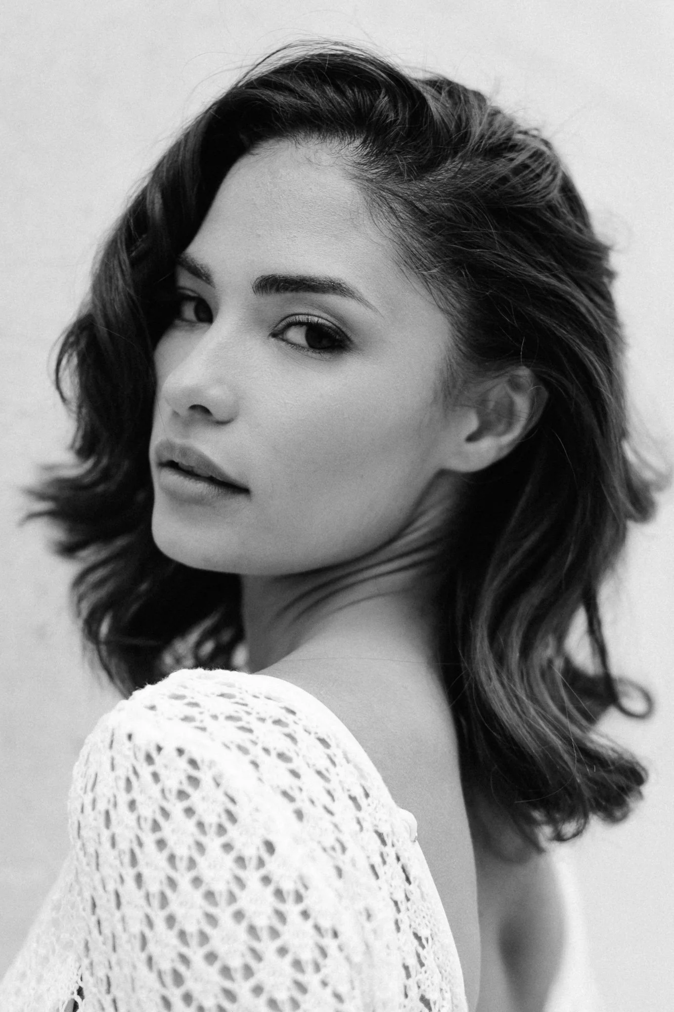 Black and white close-up portrait of woman, calm serene expression — editorial portrait photography Tuscany