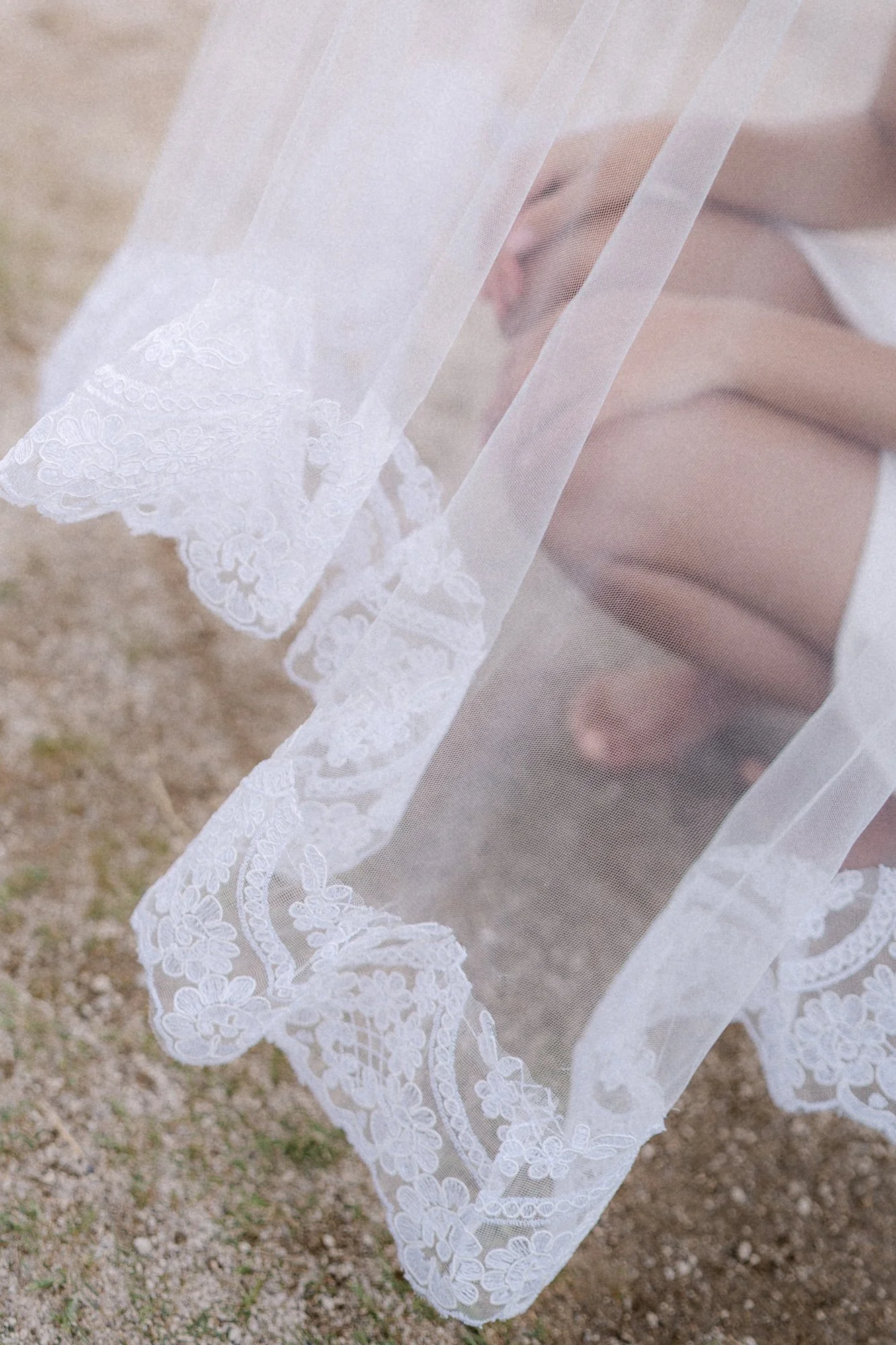 Detail of white wedding dress and veil fabric — wedding photography