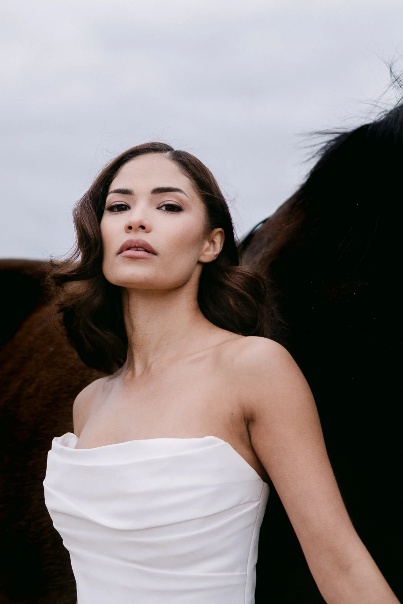 Bride in white dress in Cappadocia landscape — editorial bridal portrait photography