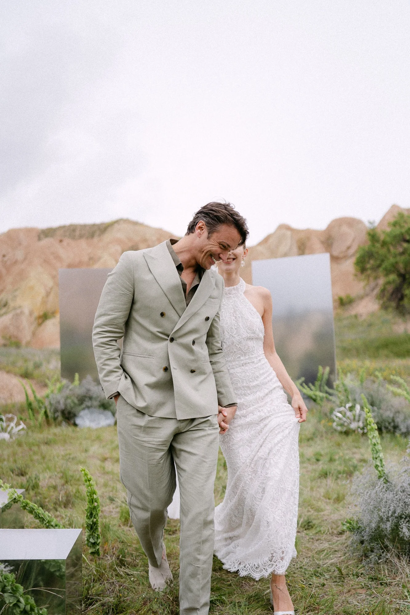 Bride and groom in an intimate embrace, Cappadocia landscape — editorial wedding photography