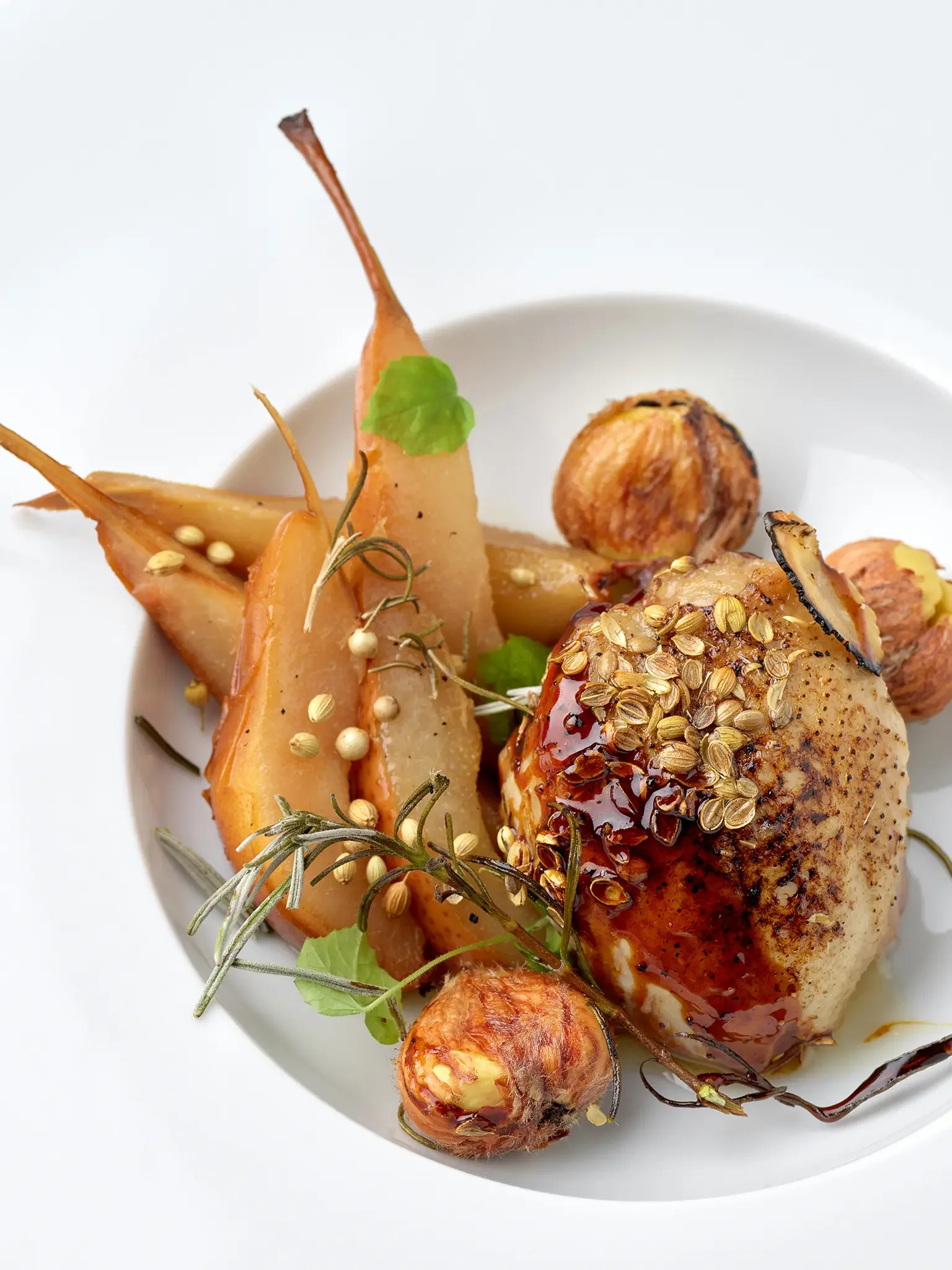 Roasted chicken breast with herbs and seeds, served with roasted vegetables and garlic.