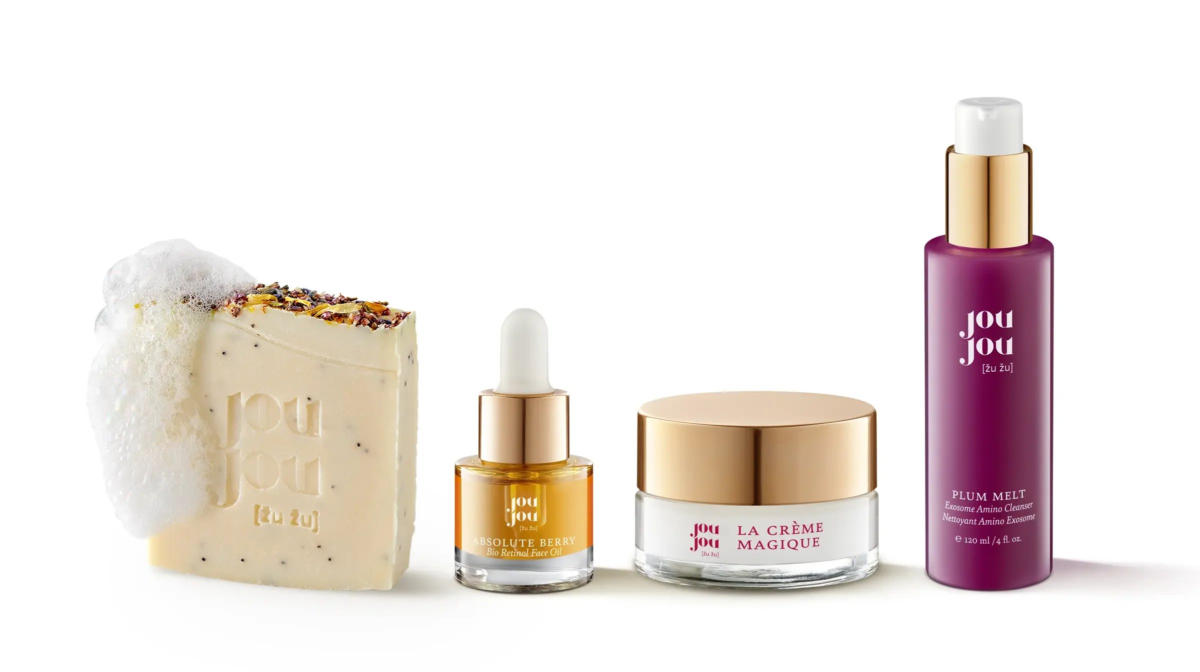 A bar of soap with foam, 2 skincare serum bottles, a jar of cream, and a spray bottle of facial mist from Jou Jou skincare brand.