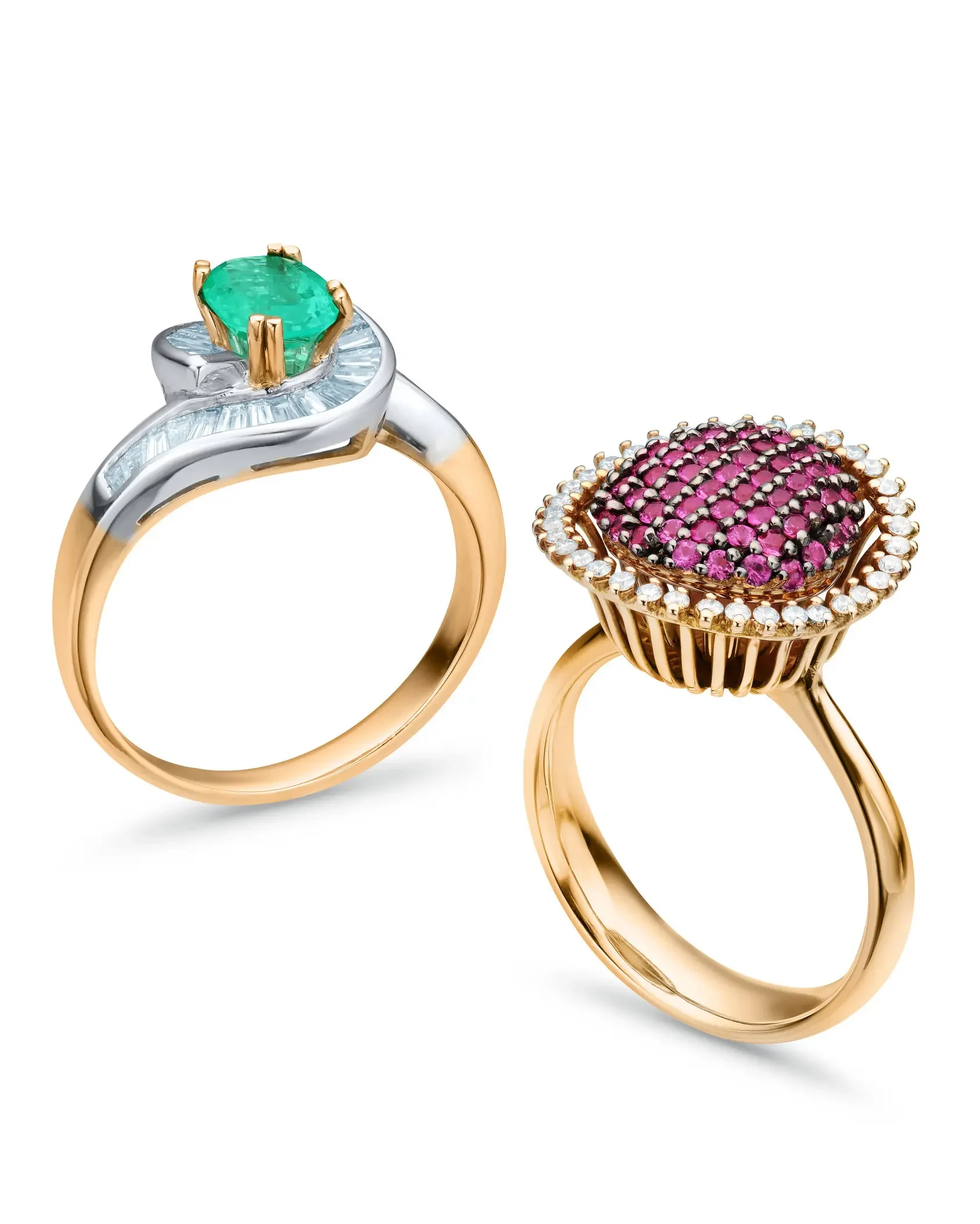 Close-up of two gold rings, one with a green gemstone and the other with pink and white gemstones.