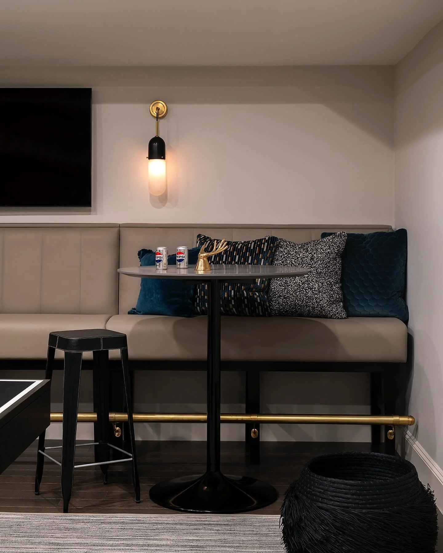 This Wellesley game room needed to work for everyone - kid and adult game nights. The custom banquette with leather and velvet textures brings sophistication, while brass details add warmth to the moody palette.

Mixed metals aren&rsquo;t about match