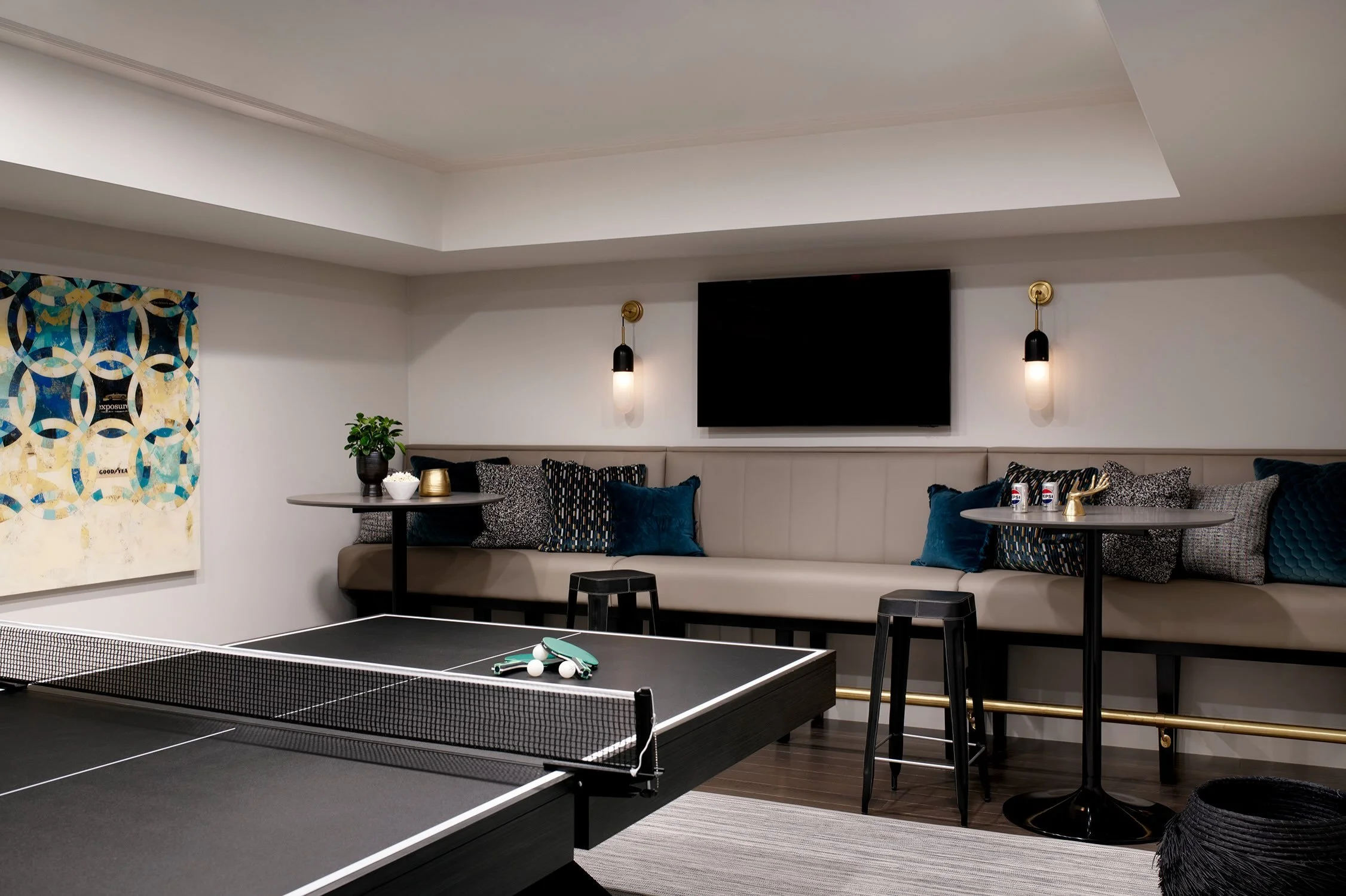 September means fall is close, and this room is a good reminder that &ldquo;considered&rdquo; doesn&rsquo;t have to mean quiet. This lower level was built for noise. A banquette instead of a single sofa, ping pong instead of formal seating, room for 