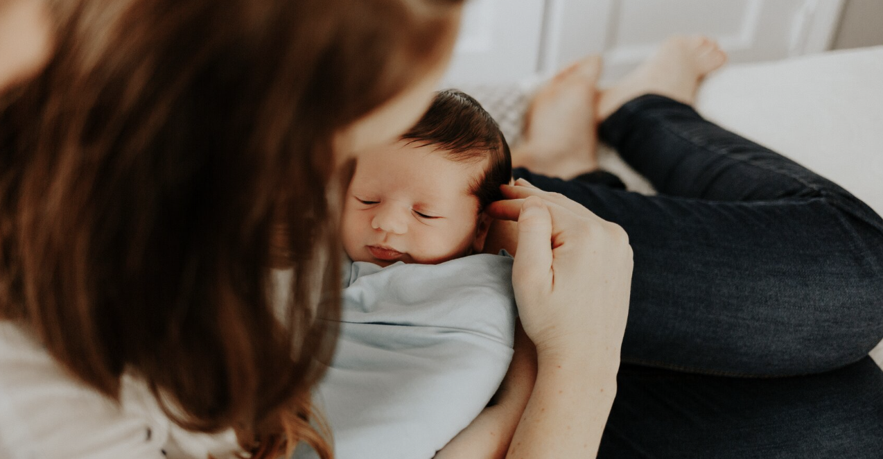 woman holding newborn baby
