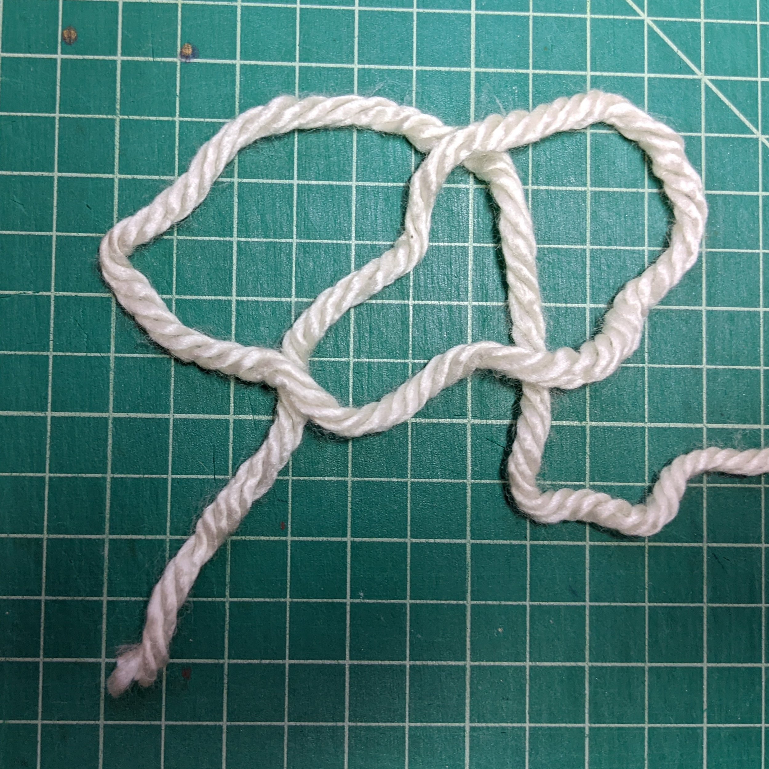 Step 4: Lay the loop back down and you should have a sort of pretzel shape