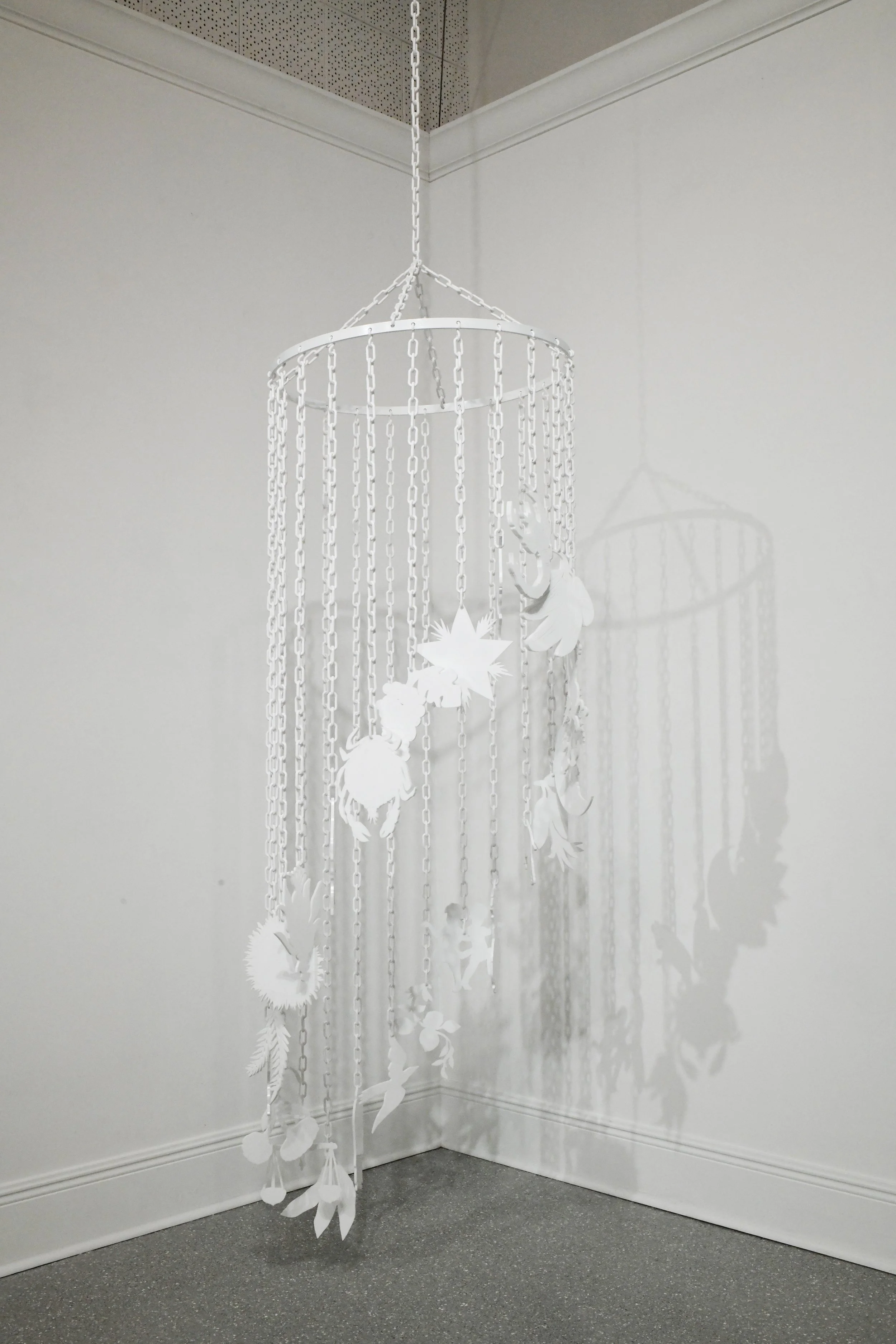 Fruits of Heaven and Earth, aluminum ring, plastic chain, laser etched and cut white acrylic, 24” x 24” x 84”, 2025