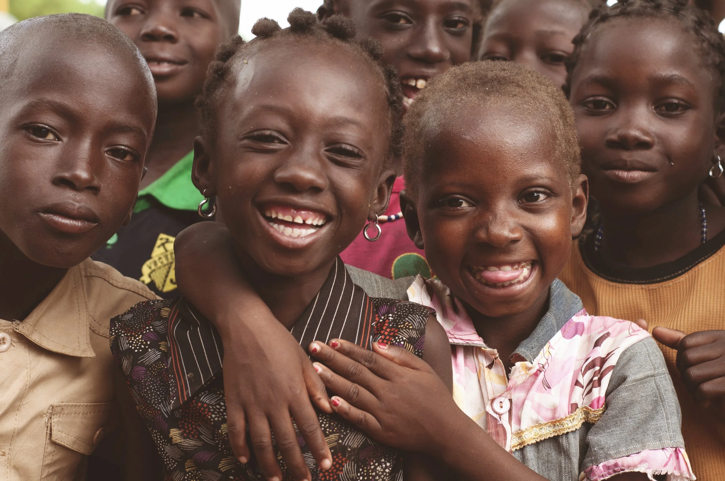 Children smiling together in Burkina Faso