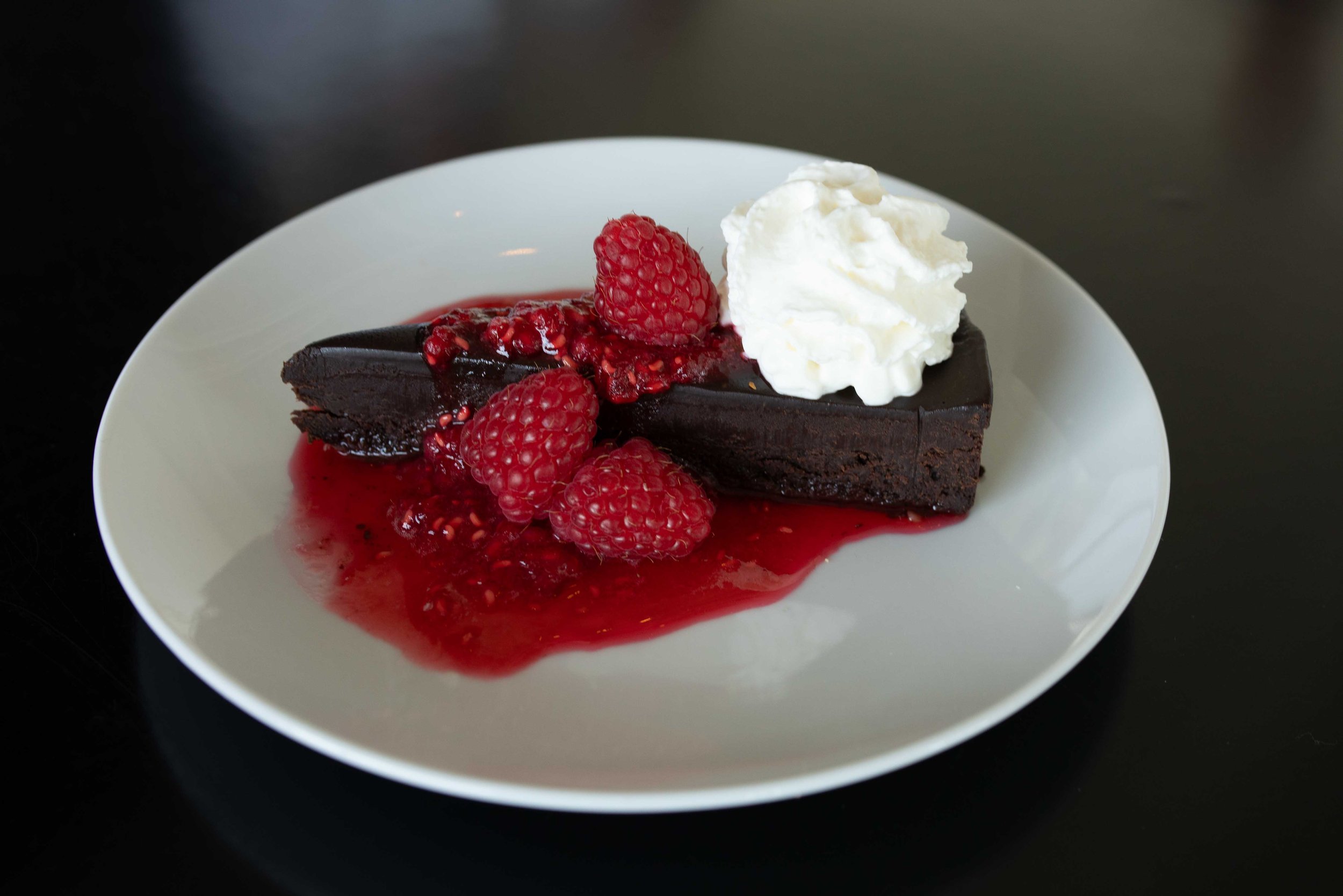 Flourless Chocolate torte with raspberry coulis and whipped cream