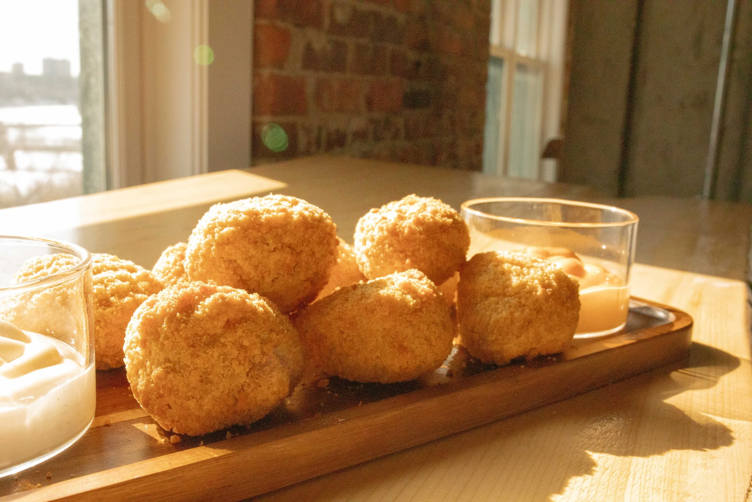 Breaded mac n’ cheese bites with garlic aioli and spicy aioli