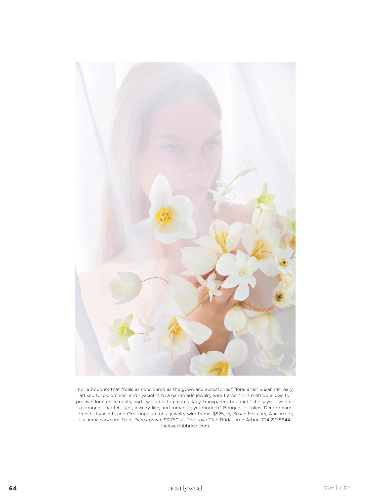 A Bride holding a bouquet of white orchids and tulips against a light background, partially obscured by a sheer, translucent fabric. hairstylist-metro-detroit-bridal-hair-updo-effortless-engaged