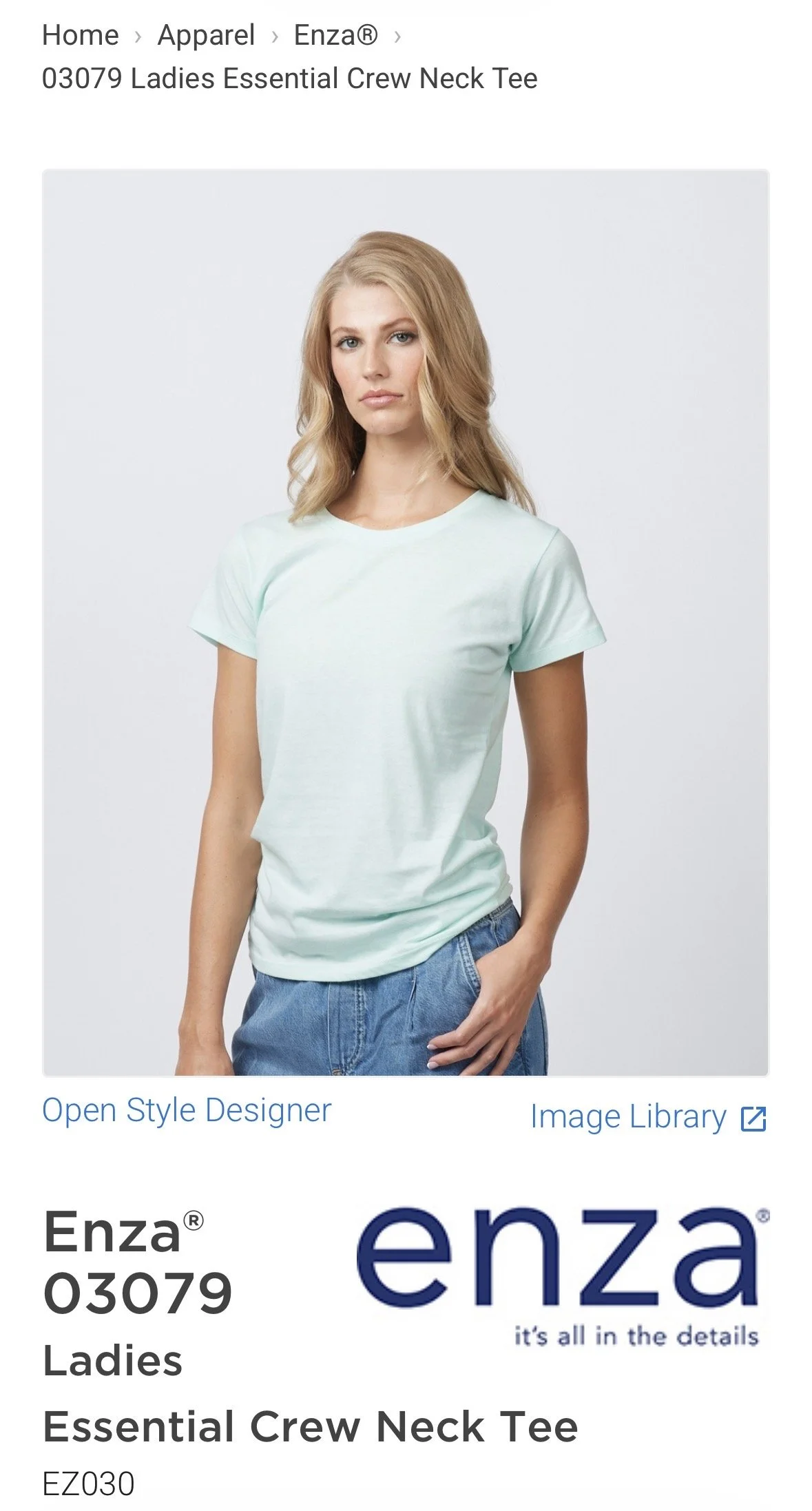 A woman with blonde hair wearing a light blue crew neck t-shirt and blue jeans, standing against a plain white background. hairstylist-metro-detroit-bridal-hair-updo-effortless-engaged
