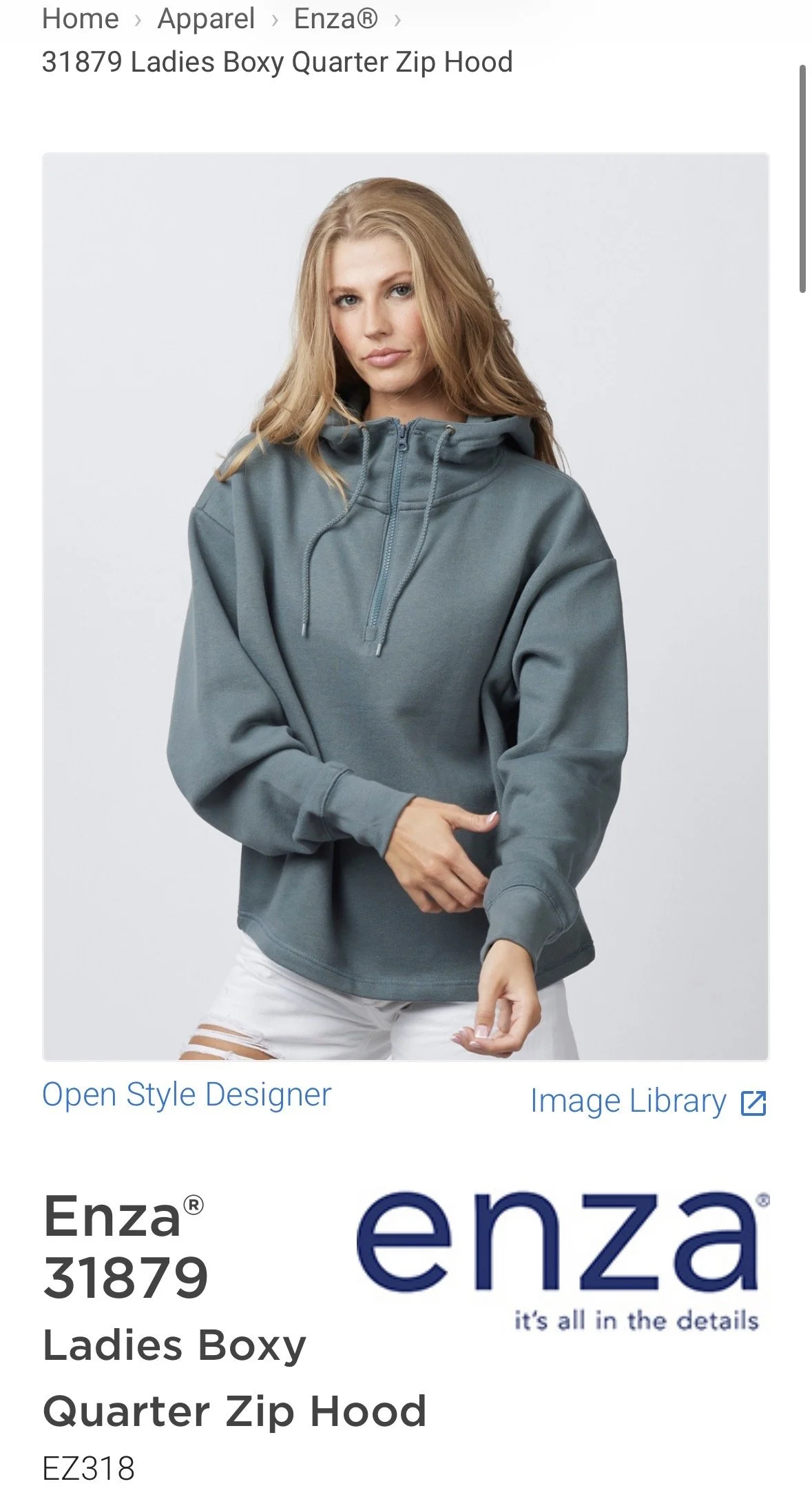 A woman with blonde hair wearing a blue quarter-zip hoodie and white ripped jeans, standing against a plain background. hairstylist-metro-detroit-bridal-hair-updo-effortless-engaged