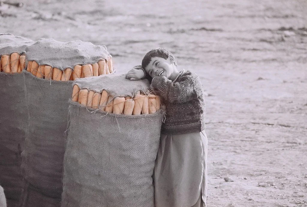 BOY SELLING CARROTS