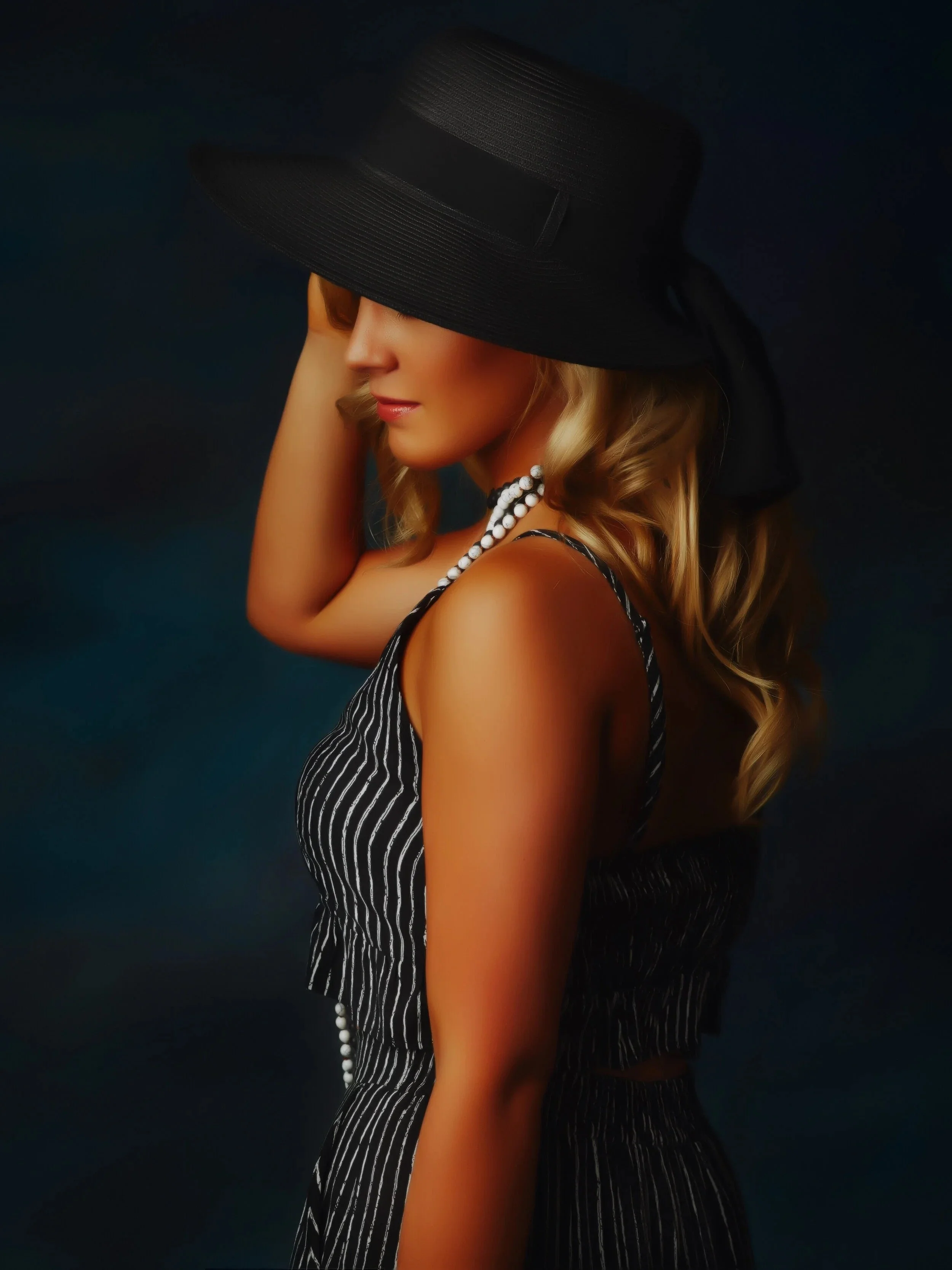 Grapevine senior pictures, girl in a large black hat, striped dress and pearl necklace