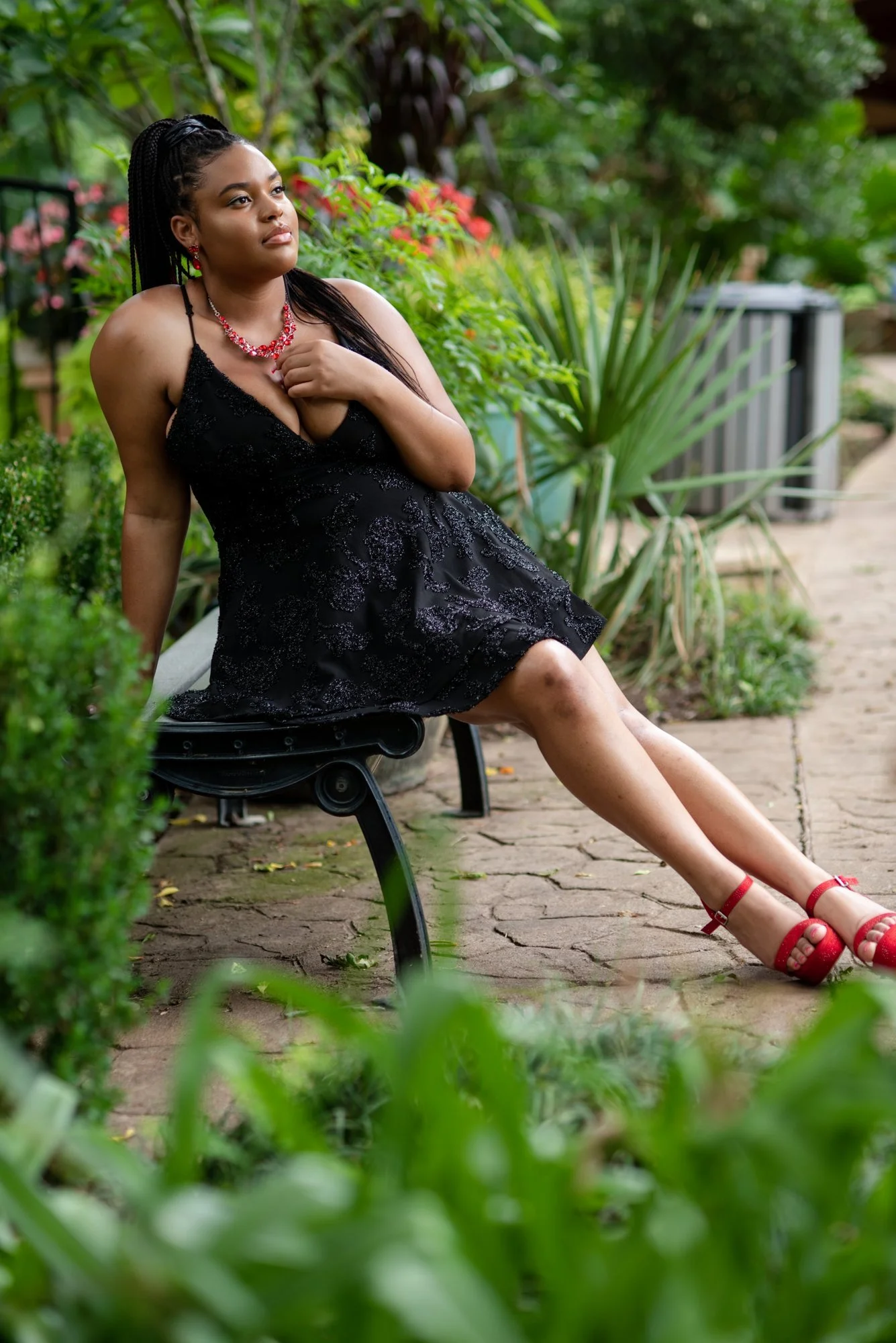 Dallas–Fort Worth senior pictures - Kelcie black dress seated in the garden