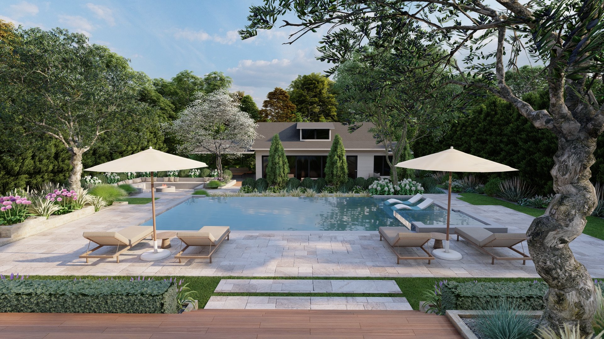 Backyard with swimming pool, lounge chairs, large trees, shrubs, and a house in the background under a blue sky.