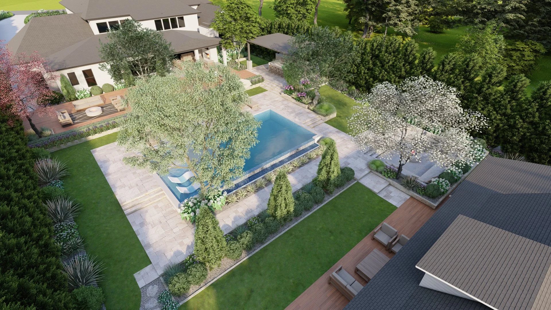 Aerial view of a backyard with a rectangular swimming pool, surrounded by green grass, trees, and landscaped plants. There is a patio area with outdoor furniture and a covered seating area next to the house.