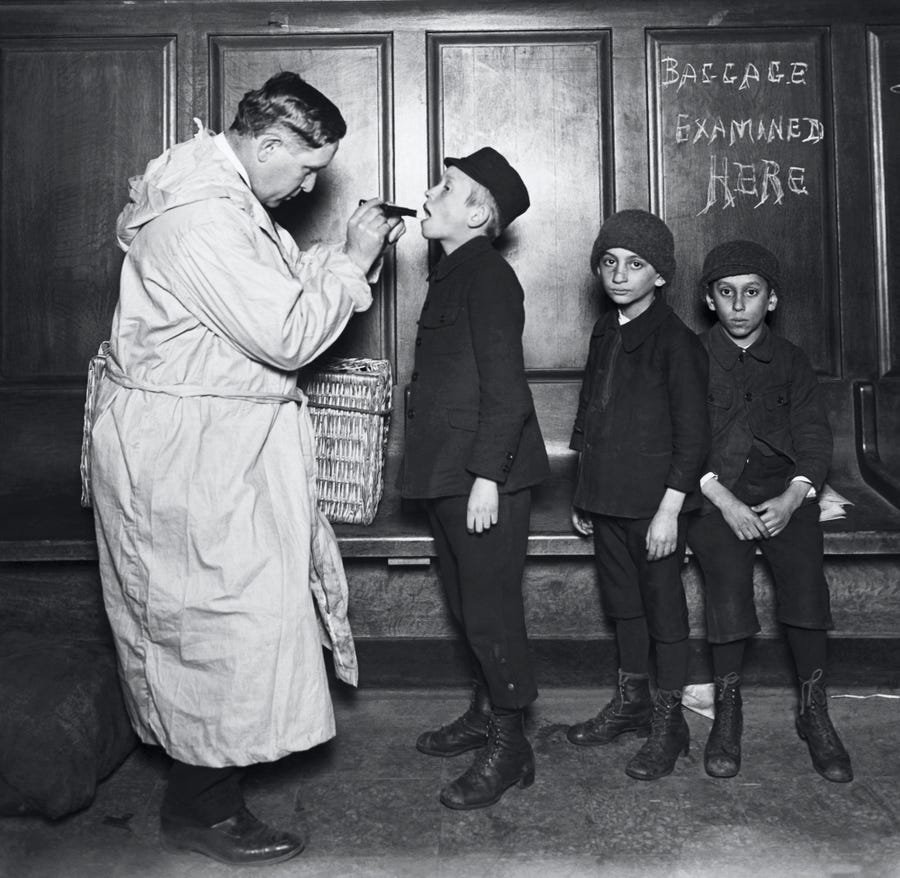Immigrant children being examined by city health officer upon arrival at the battery from Ellis Island, New York during Typhus Scare in 1911