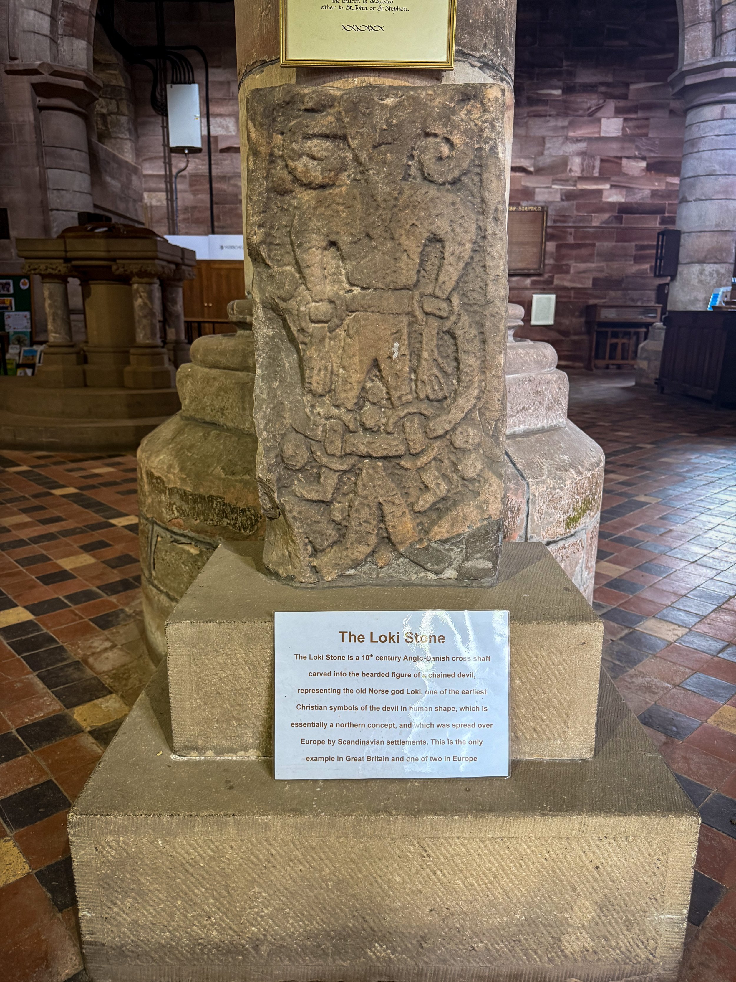 A stone carved with the image of Loki norse god in a church