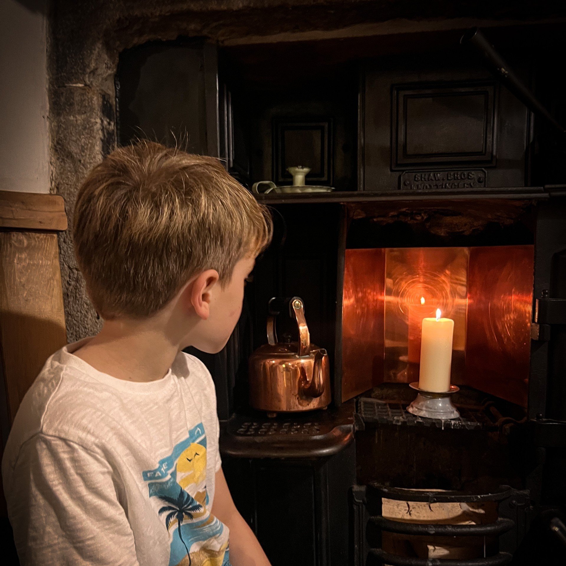 Sitting in front of iron kitchen fireplace with candles