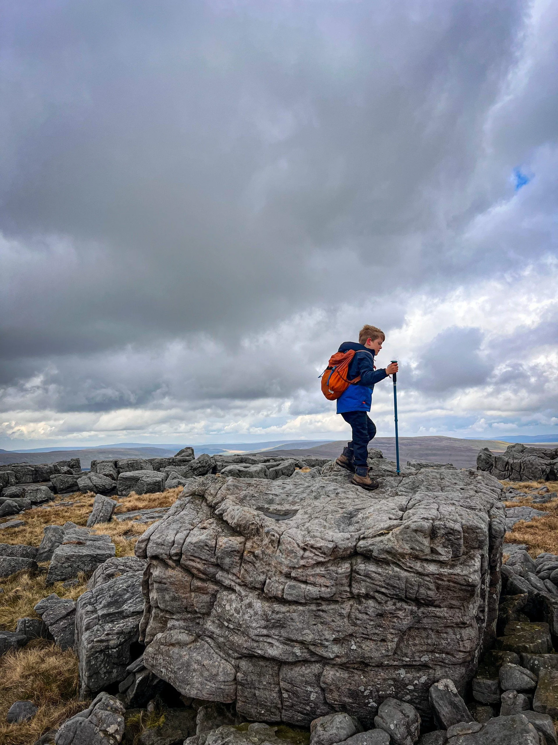 Child standing on large rock