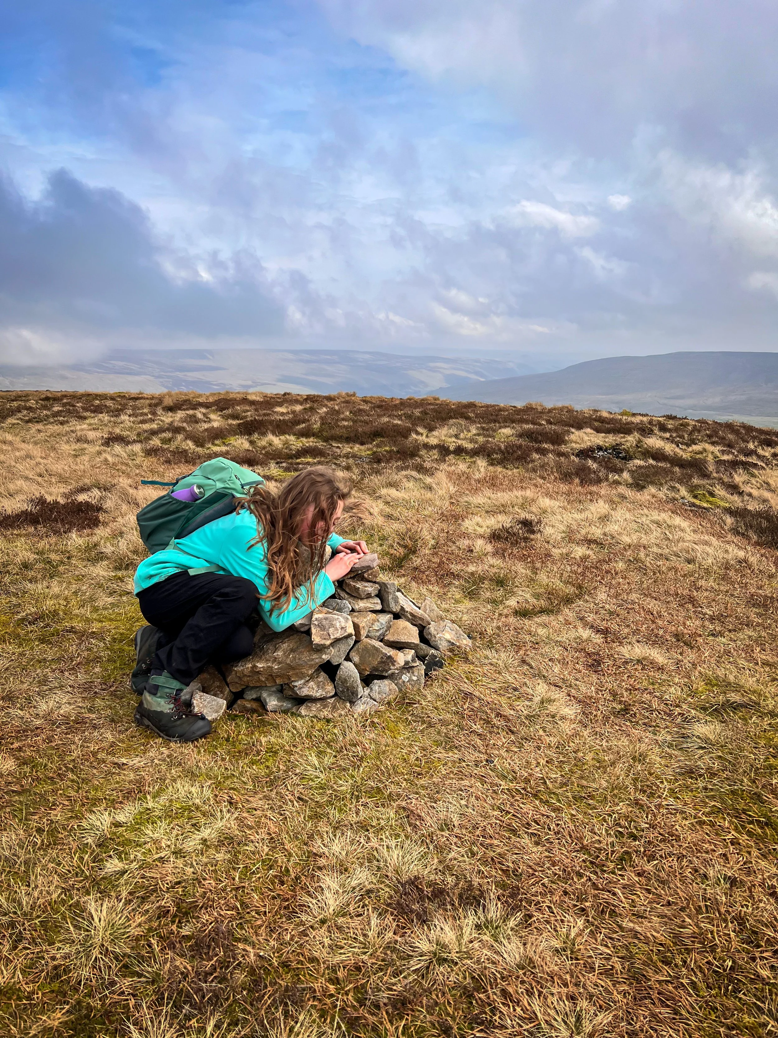 Child st hugging a tiny pile of rocks