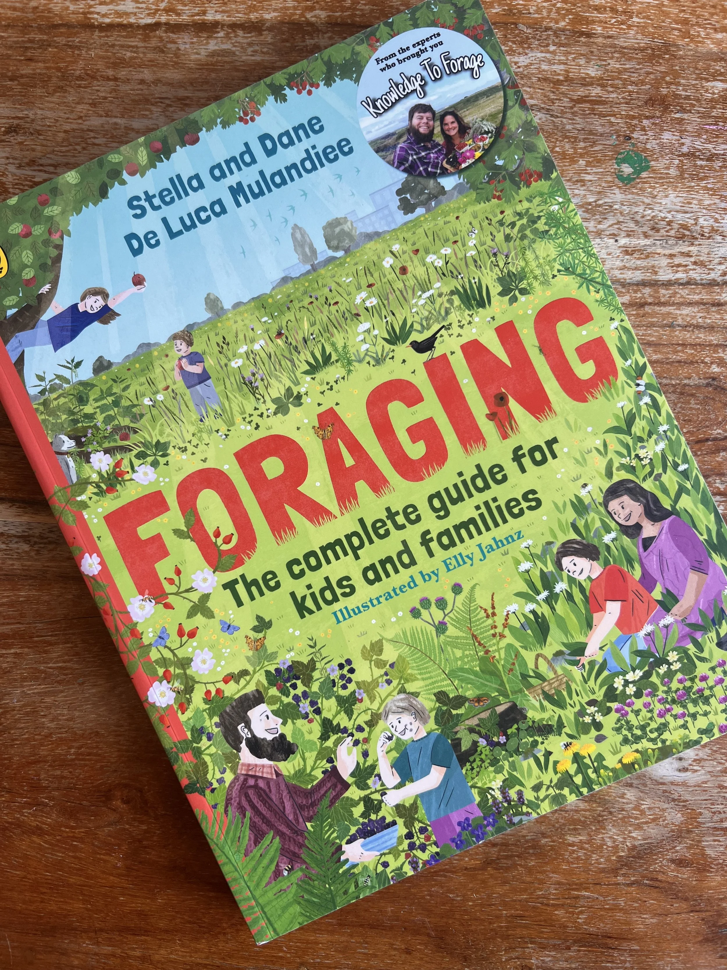A childrens foraging book front cover on a wooden table