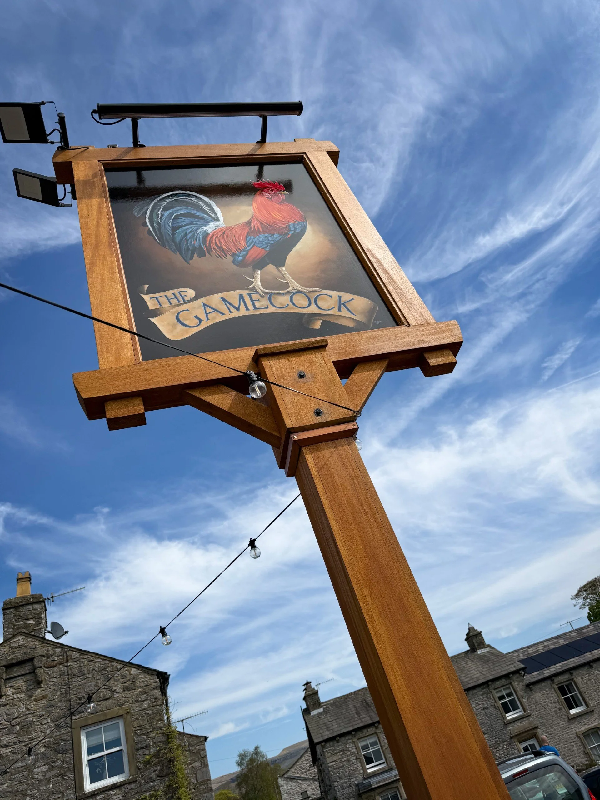 A sign for the Game Cock Pub