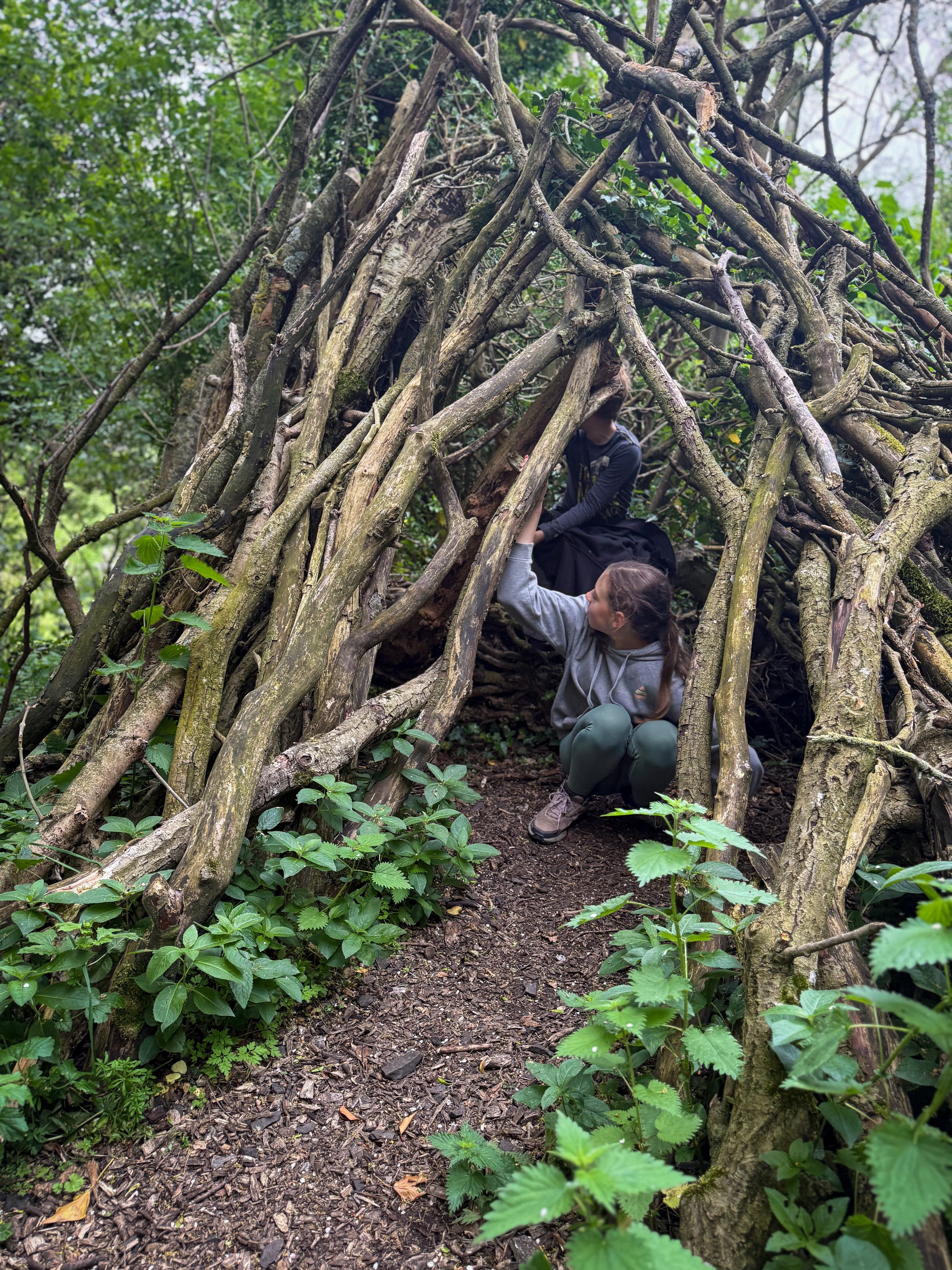 Children inside a stick den